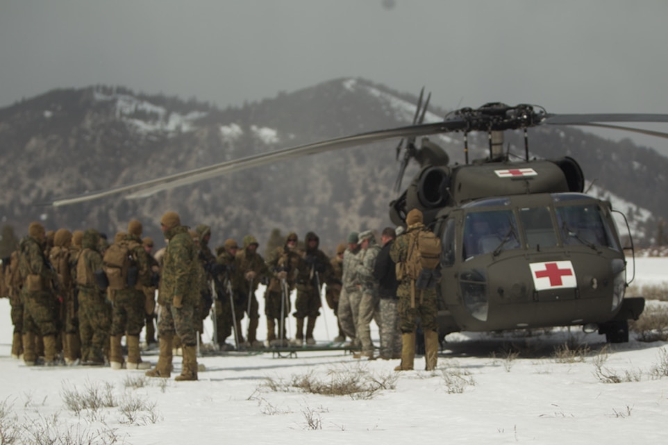 Marines are given a brief on the procedures for a medical evacuation in front of a Black Hawk helicopter at Marine Corps Mountain Warfare Training Center Bridgeport, Calif. April 5, 2012.