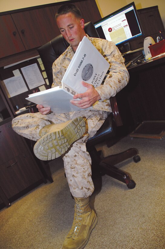 Capt. Tyler Gludt, deputy staff judge advocate, Marine Corps Logistics Base Albany, reads the Joint Ethics Regulations governing community support requests.