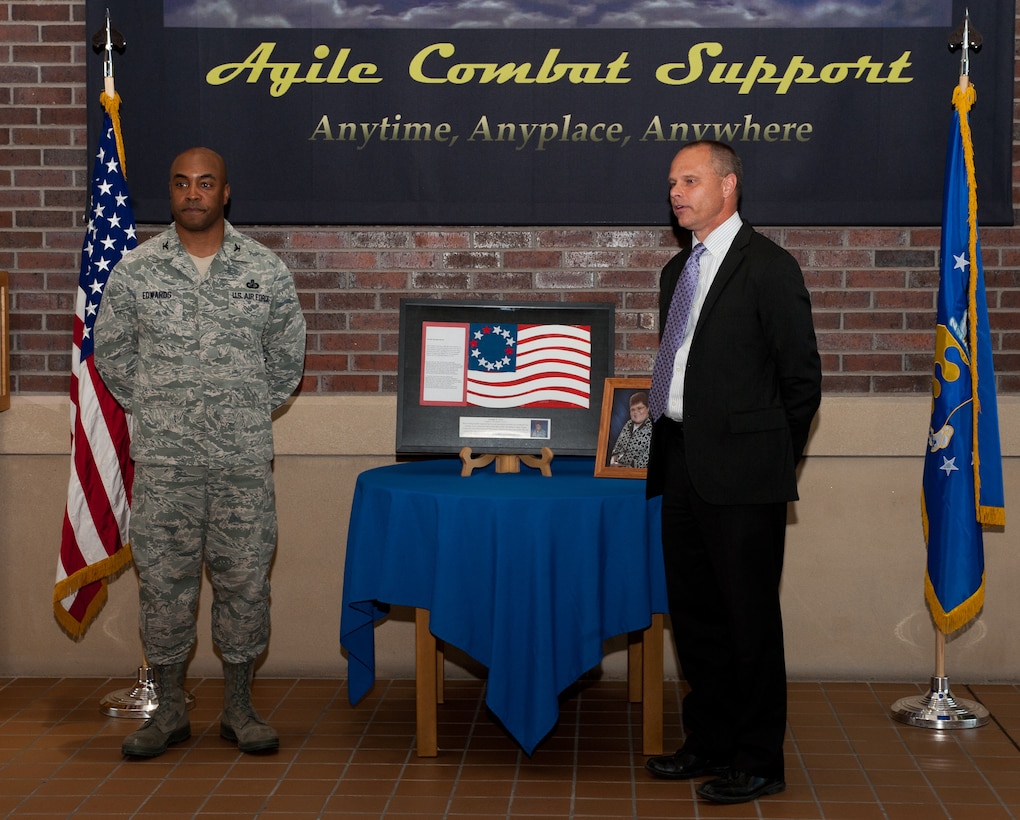 Col. Trent Edwards, 28th Mission Support Group commander, listens to Brad Saathoff, Suzie Cappa Art Center chief executive officer, relate Jennifer Avery’s love and respect for service members during a presentation of the artwork at Ellsworth Air Force Base, S.D., April 4, 2012. During the last years of Jennifer’s life, she created a piece of artwork that she wanted to be presented to Ellsworth to honor members of the armed forces. (U.S. Air Force photo by Airman 1st Class Alystria Maurer/Released)