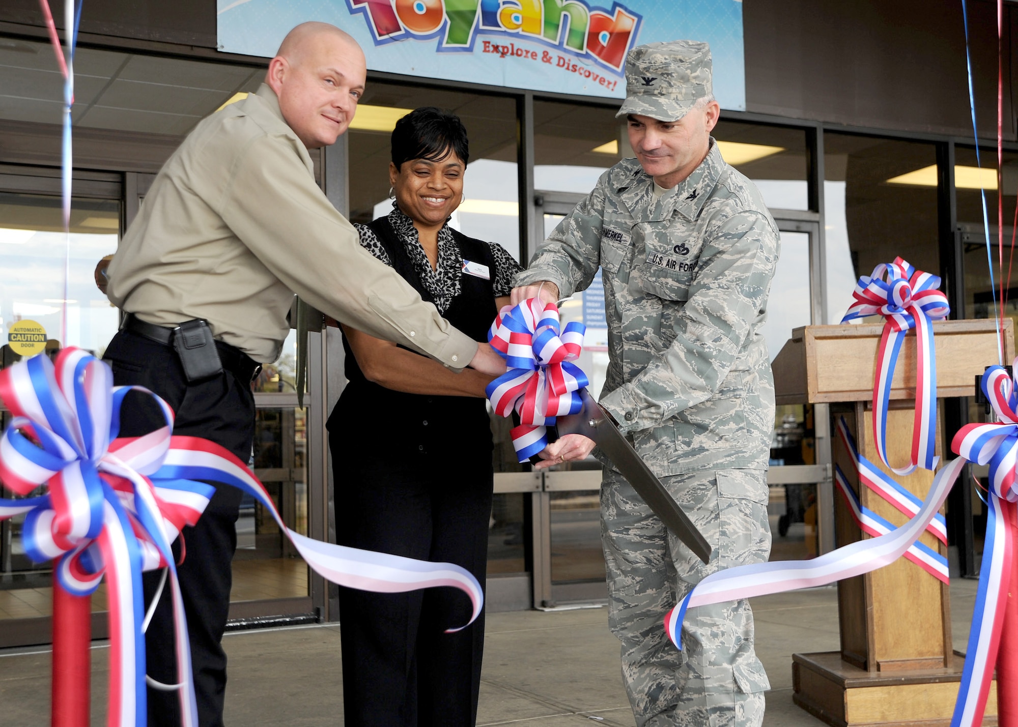 Gregory Rosenmerkel, 11th Mission Support Group commander, Sha Carter, Andrews Home and Garden Outdoor Living Center manager and Chris Holifield, the Andrews Main Exchange general manager cut a ribbon signifying the opening of the home and garden section at the Home Traditions store on Joint Base Andrews, Md. on March 30  The new addition to the store is part of a strategy to  consolidate their operations for customer convenience. (U.S. Air Force photo/Staff Sgt. Matt Coleman-Foster)