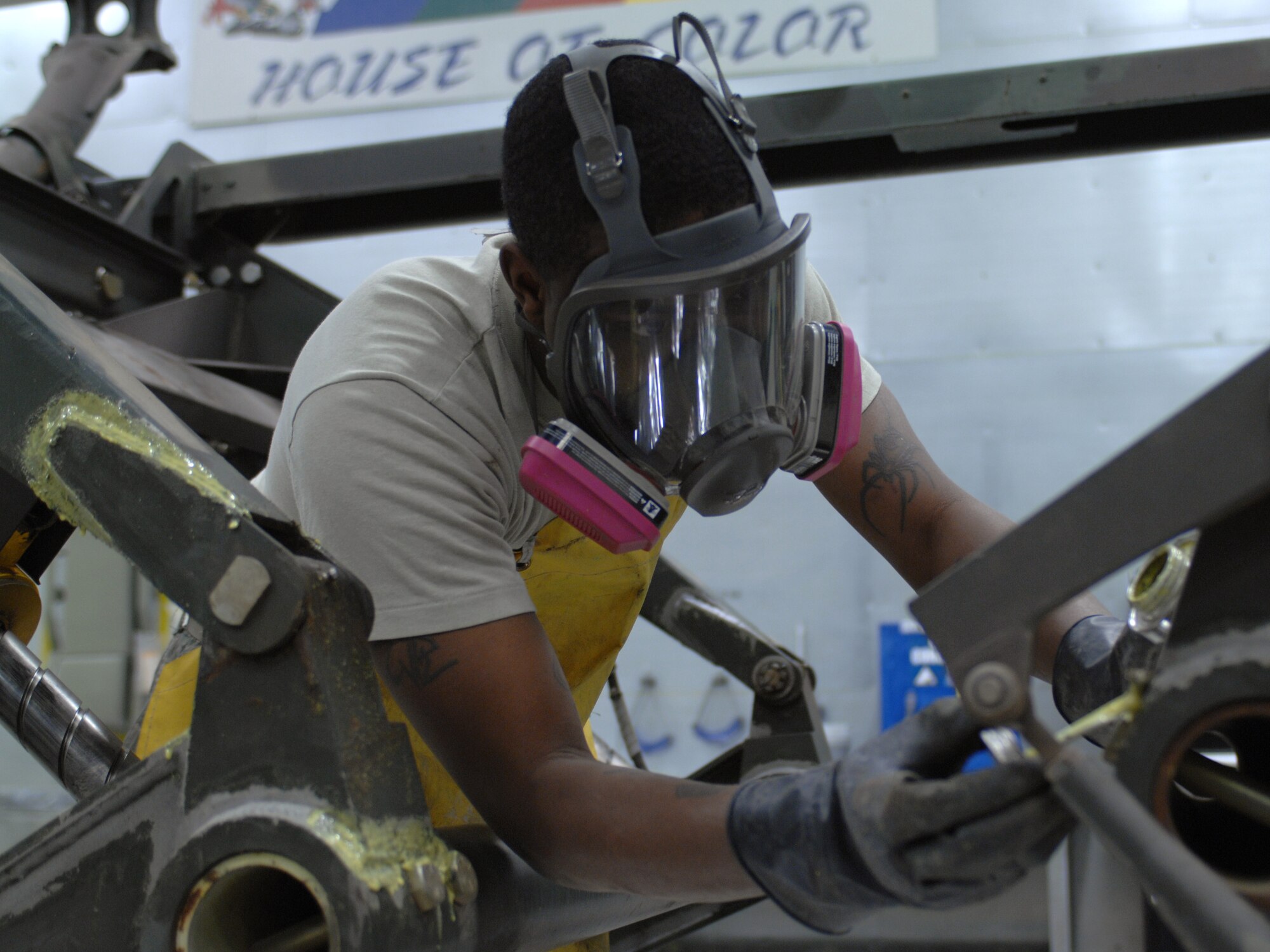 U.S. Air Force Senior Airman William Pinkney, 355th Equipment Maintenance Squadron aircraft structural maintenance, applies paint stripper to the welds of an engine trailer at the paint barn on Davis-Monthan Air Force Base, Ariz., April 3. The paint needs to be removed from the welds so they can be checked for cracks. (U.S. Air Force photo by Airman 1st Class Michael Washburn/Released) 