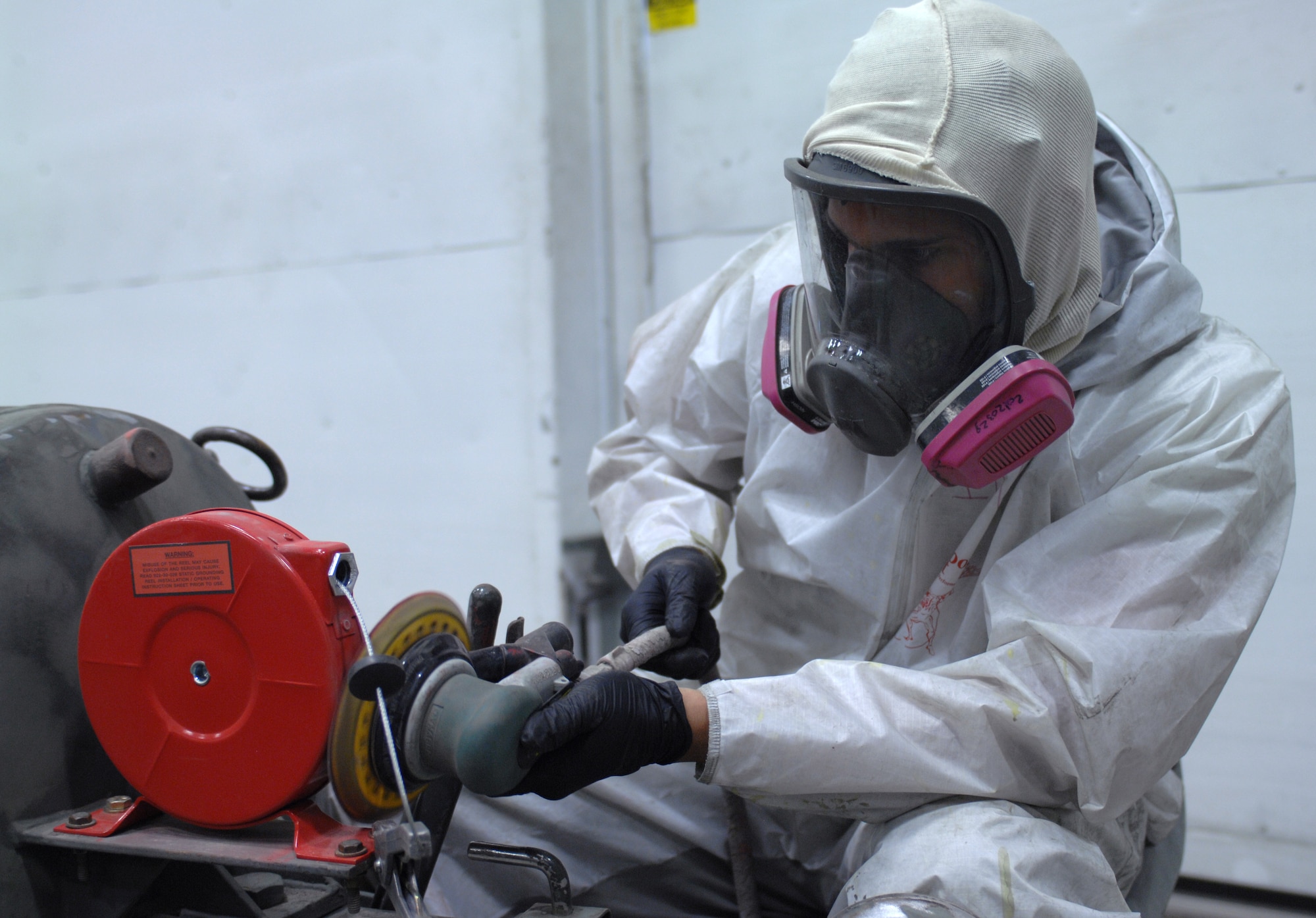 U.S. Air Force Airman 1st Class Hank Chaney, 355th Equipment Maintenance Squadron aircraft structural maintenance, sands down a liquid oxygen tank to be repainted at the paint barn on Davis-Monthan Air Force Base, Ariz., April 3. The Airmen are trying to stop the disastrous spread of rust and corrosion on the equipment the men and women of D-M use every day. (U.S. Air Force photo by Airman 1st Class Michael Washburn/Released)