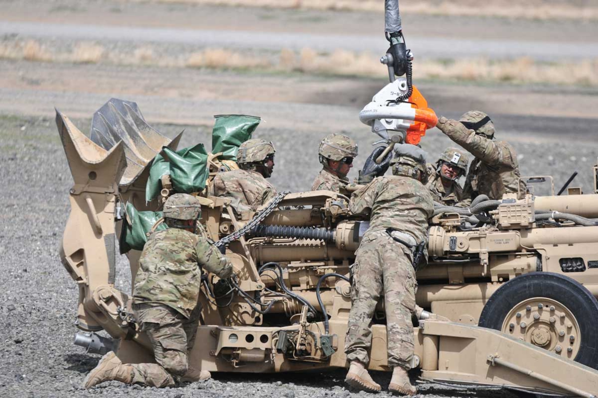 Paratroopers of Task Force Spartan Steel and Task Force Centurion work together to sling load an M777 155-mm howitzer. The M777 howitzer was transported to Combat Outpost Chamkani from Forward Operating Base Salerno March 28. The lightweight M777 recently replaced the M198 155-mm howitzer, and uses a digital fire control system. (U.S. Army photo/Spc. Eric-James Estrada)