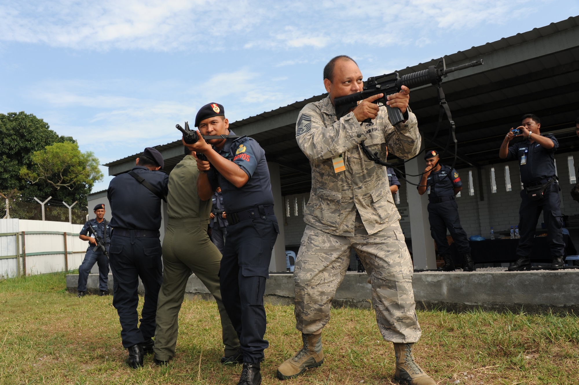Chief Master Sgt. William Makaneole, Pacific Air Forces plans and programs project officer, leads Royal Malaysian Air Force airmen from Provost Squadron 104 in a stack formation during a subject matter expert exchange at Cope Taufan 2012 at TUDM Butterworth Apr. 5, 2012. (U.S. Air Force photo/Master Sgt. Matt Summers/released)