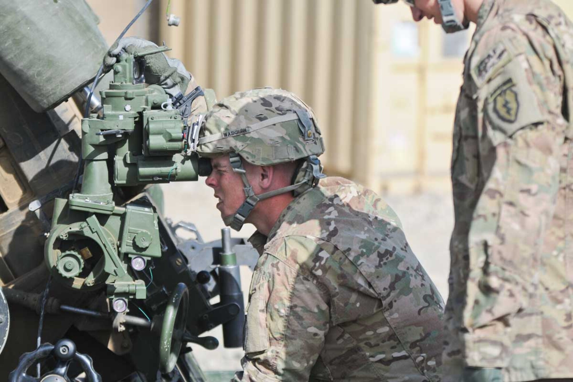 Sgt. Johnny Washburn, a native of El Reno, Okla., and a howitzer gunner, dials in a good sight picture on an  M-119 105-mm howitzer at Combat Outpost Herrera, March 26. Washburn is part of B Battery, 2nd Battalion, 377 Parachute Field Artillery Regiment, Task Force Spartan Steel. Soldiers of B Battery fire howitzers in direct support of infantrymen of 3rd Battalion (Airborne), 509th Infantry Regiment. (U.S. Army photo/Staff Sgt. Jason Epperson)