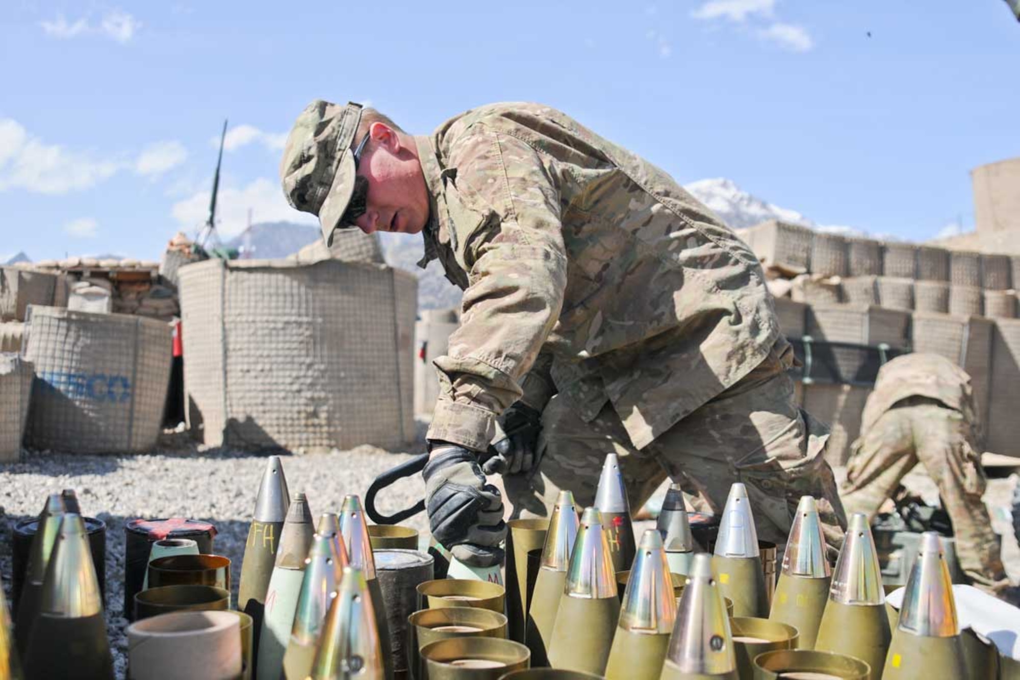 Spc. Adam Baughman Linton, who hails from Linton, Ind., screws fuzes on a M84A1 Hydrochloric smoke round at COP Herrera March 26. (U.S. Army photo/Staff Sgt. Jason Epperson)