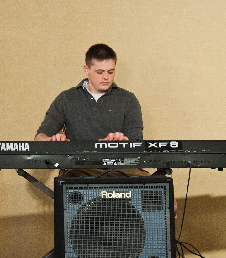 Senior Airman James Chamberlain, 28th Operations Support Squadron assistant unit deployment manager, performs an original melody on his keyboard during Ellsworth’s Got Talent contest at the Dakotas Club on Ellsworth Air Force Base, S.D., March 24, 2012. The song Chamberlain played was a combination of various classical works and medleys. (U.S. Air Force photo by Airman 1st Class Alystria Maurer/Released)