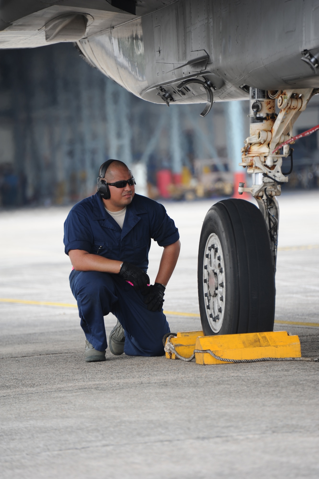 Staff Sgt. Gilbert Palos, 18th Component Maintenance Squadron fuel systems craftsman, prepares to pull chocks during the first full day of flying in Cope Taufan 2012 at TUDM Butterworth in northwestern Malaysia Apr. 4, 2012. Cope Taufan, the biennial live-flying exercise between the U.S. Air Force and RMAF, includes dissimilar basic fighter maneuvers and dissimilar air combat tactics training. (U.S. Air Force photo/Master Sgt. Matt Summers/released)