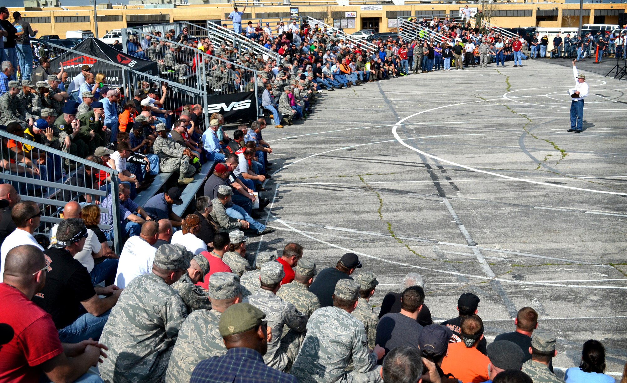 Hundreds of Tinker riders listen as Mark “The Safety Guy” Sprayberry encourages riders to heed safety guidelines and discusses risks unique to riding in Oklahoma during the Pre-Season Riders Briefing.. The event was hosted by the 72nd Air Base?Wing Safety office and the Navy’s Stratcomm Wing One Motorcycle Safety program, who cooked burgers and sponsored a stunt-rider demonstration team. (Air Force photo by Micah Garbarino)