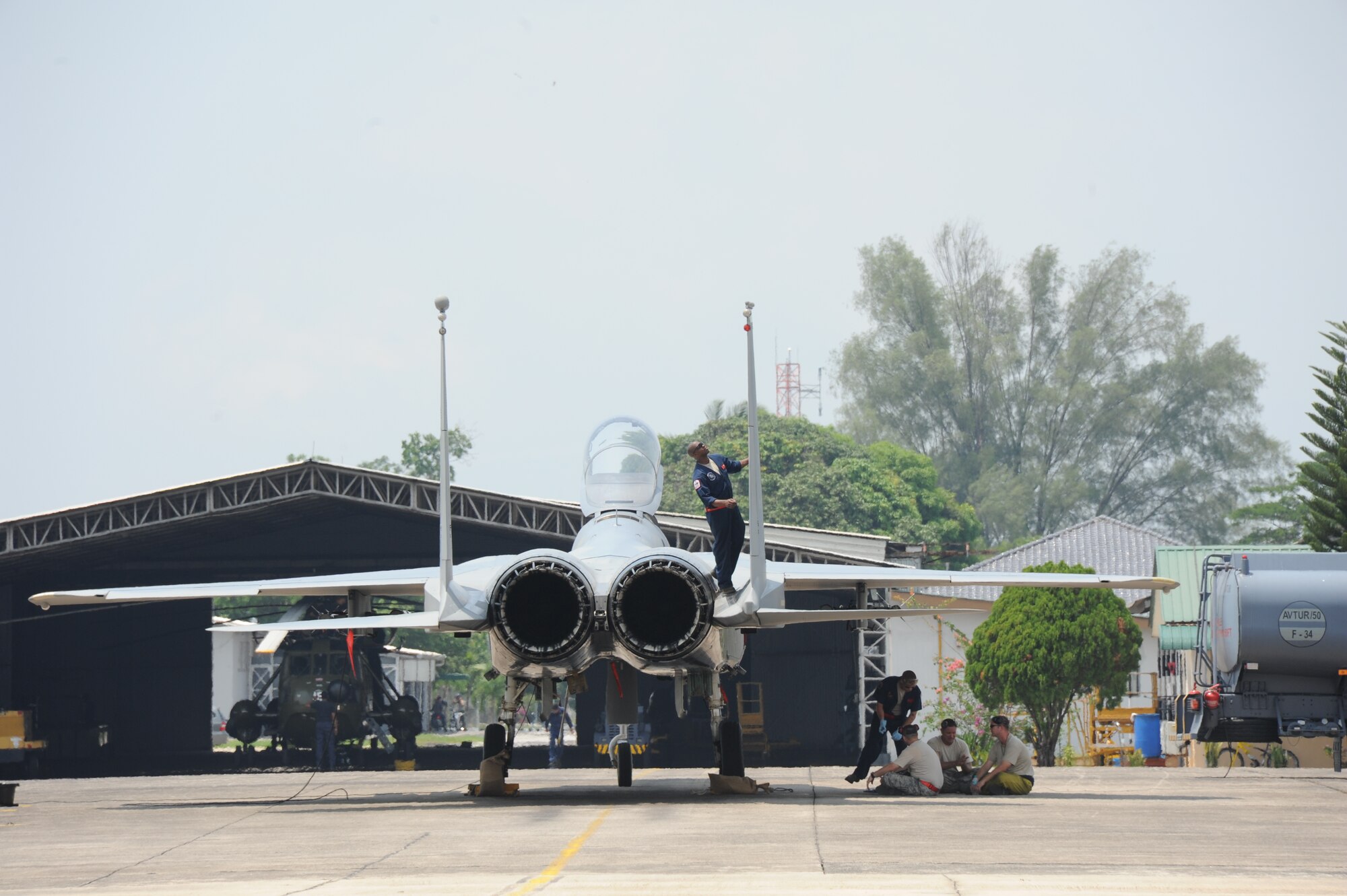 Senior Airman Christopher Smith, 67th Aircraft Maintenance Squadron crew chief, performs pre-flight checks on an F-15C during the first full day of flying during Cope Taufan 2012 at TUDM Butterworth in northwestern Malaysia Apr. 4, 2012. Cope Taufan, the biennial live-flying exercise between the U.S. Air Force and RMAF, includes dissimilar basic fighter maneuvers and dissimilar air combat tactics training. (U.S. Air Force photo/Master Sgt. Matt Summers/released)