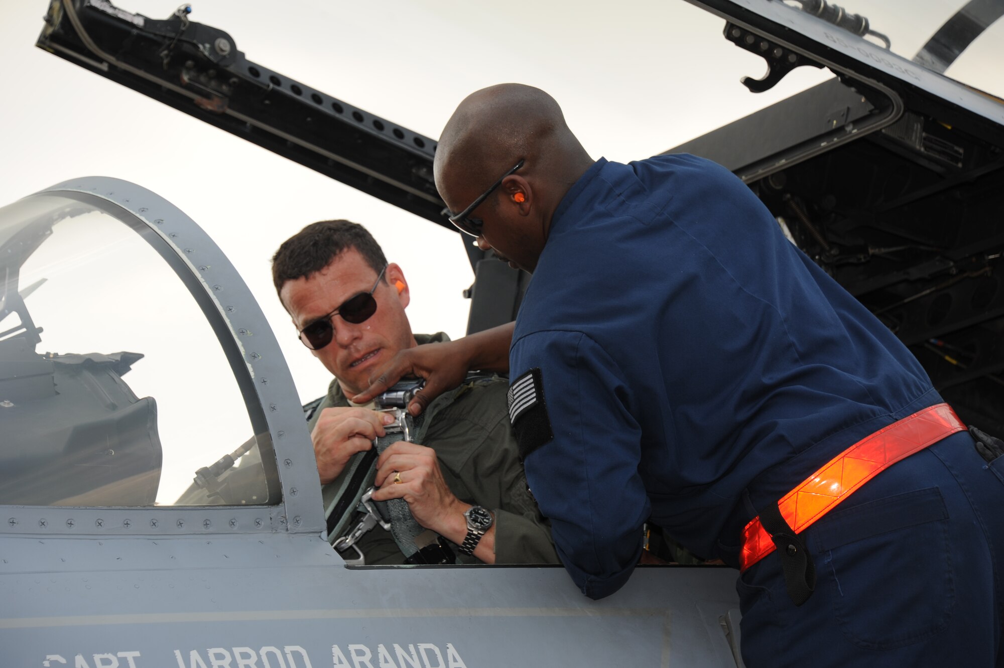 Senior Airman Christopher Smith (right), 67th Aircraft Maintenance Unit crew chief, helps Brig. Gen. Matthew Molloy, 18th Wing commander at Kadena Air Base, Japan, strap in prior to a sortie during the first full day of flying at Cope Taufan 2012 at TUDM Butterworth in northwestern Malaysia Apr. 4, 2012. Molloy, a command pilot with more than 3,200 hours in the F-15 and F-22, commands the largest combat wing in the Air Force. Cope Taufan, the biennial live-flying exercise between the U.S. Air Force and RMAF, includes dissimilar basic fighter maneuvers and dissimilar air combat tactics training. (U.S. Air Force photo/Master Sgt. Matt Summers/released)