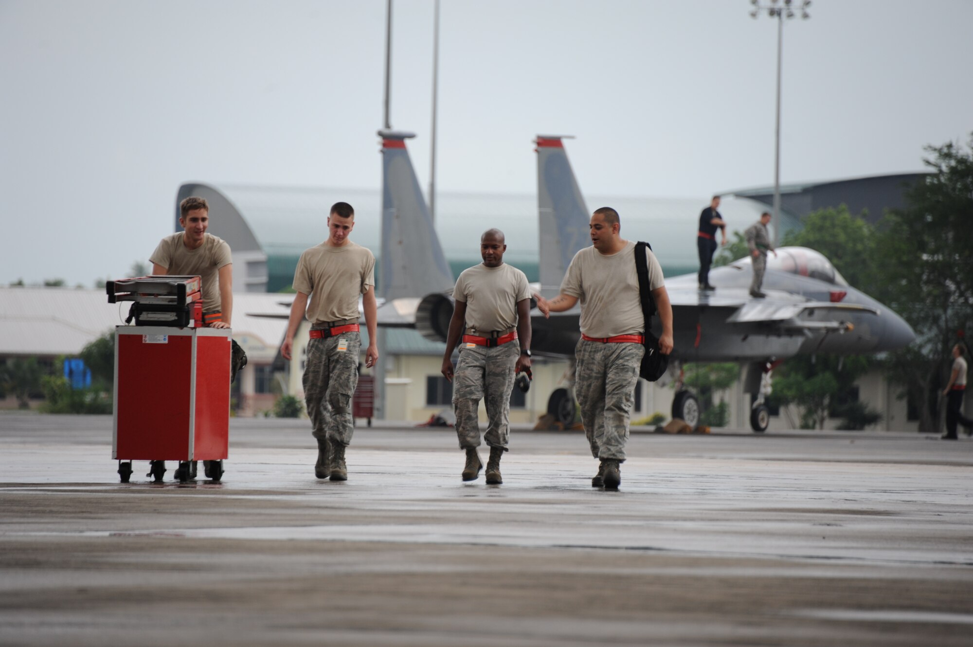 Airmen from the 67th Aircraft Maintenance Unit based at Kadena Air Base, Japan, leave the flightline during Cope Taufan 2012 at TUDM Butterworth Apr. 3, 2012. Cope Taufan, the biennial live-flying exercise between the U.S. Air Force and RMAF, includes dissimilar basic fighter maneuvers and dissimilar air combat tactics training.  (U.S. Air Force photo/Master Sgt. Matt Summers/released)