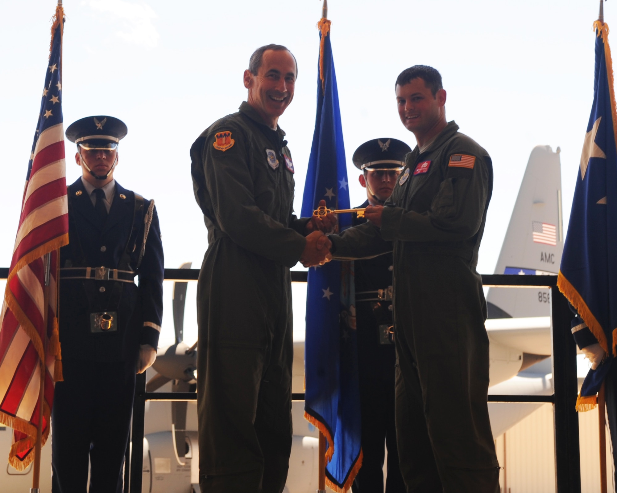 Gen. Raymond Johns, Air Mobility Command commander, Scott Air Force Base, Ill., presents the honorary key to Staff Sgt. Jakob Howell, 317th Aircraft Maintenance Squadron, April 4, 2012, at Dyess Air Force Base, Texas. The aircraft is the 17th of 28 to be delivered to Dyess by 2012, replacing the legacy fleet of the C-130 H model. (U.S. Air Force photo by Airman 1st Class Cierra Bullock)