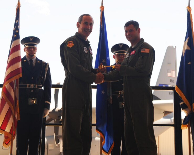 Gen. Raymond Johns, Air Mobility Command commander, Scott Air Force Base, Ill., presents the honorary key to Staff Sgt. Jakob Howell, 317th Aircraft Maintenance Squadron, April 4, 2012, at Dyess Air Force Base, Texas. The aircraft is the 17th of 28 to be delivered to Dyess by 2012, replacing the legacy fleet of the C-130 H model. (U.S. Air Force photo by Airman 1st Class Cierra Bullock)