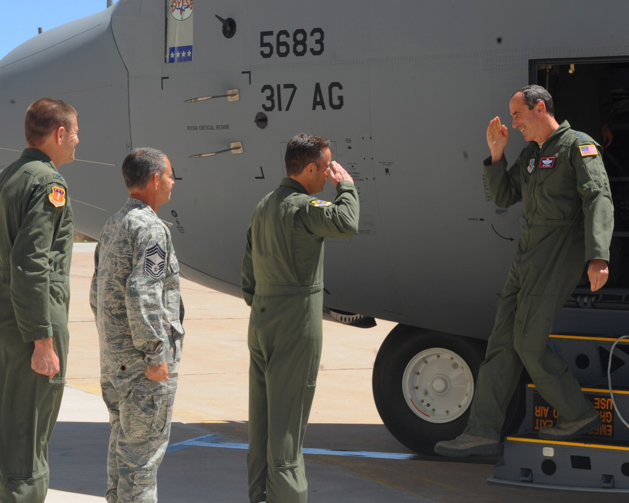 Col. Gerald Goodfellow, 7th Bomb Wing vice commander, salutes Gen. Raymond Johns, Air Mobility Command commander, Scott Air Force Base, Ill., as he exits Dyess’ newly acquired aircraft April 4, 2012, at Dyess Air Force Base, Texas. The aircraft is the 17th of 28 to be delivered to Dyess, replacing the legacy fleet of the C-130 Hercules model. (U.S. Air Force photo by Airman 1st Class Cierra Bullock)