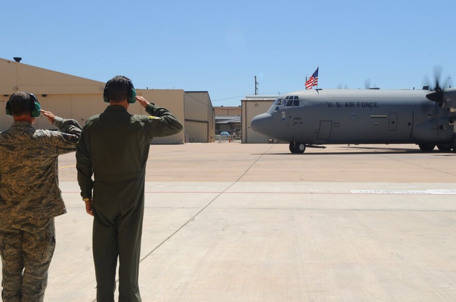 Col. Todd McCready, left, 7th Maintenance Group commander, and Col. Gerald Goodfellow, right, 7th Bomb Wing vice commander, salute Gen. Raymond Johns, Air Mobility Command commander, Scott Air Force Base, Ill., April 4, 2012  as he taxis in the newest J- model at Dyess Air Force Base, Texas .  The aircraft is the 17th of 28 to be delivered to Dyess, replacing the legacy fleet of the C-130 Hercules model. (U.S. Air Force photo by Airman 1st Class Cierra Bullock)