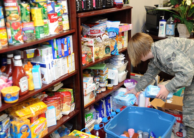 Senior Airman Amy Breeden, 11th Logistics Readiness Squadron vehicle operator, organizes food and household items March 30. The items were donated to the Andrews Attic in support of families effected by a base housing fire that occurred March 29. (U.S. Air Force photo/Senior Airman Laura Turner)