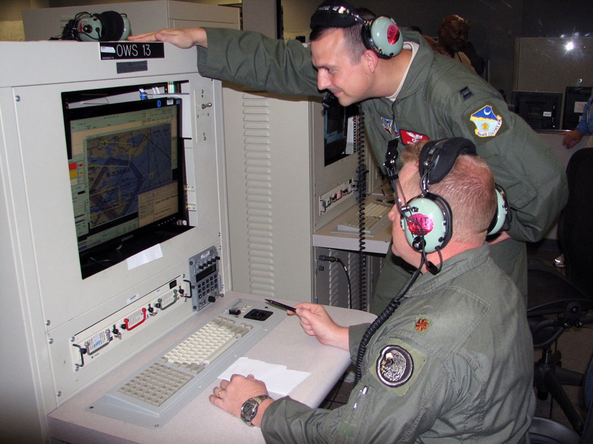 Maj. Jon Prindle and Capt. Michael Povilus, with the 16th Air Command and Control Squadron, demonstrate the platform used for the recent Virtual Flag exercise.( U.S. Air Force photo by Angie Parise)