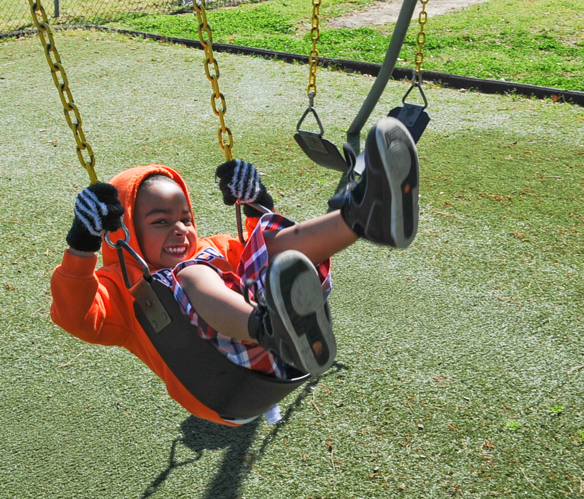 Alexander Johnson, 3, swings on the playground at the child development center on Seymour Johnson Air Force Base, N.C., April 3, 2012. The Department of Defense recognizes April as the Month of the Military Child; honoring these children for their selflessness and the sacrifices they make each day. Alexander is the son of U.S. Air Force Staff Sgts. Brianna and Cameron Johnson. Brianna is an installation personnel journeyman at the 4th Force Support Squadron. Cameron is a base command operations controller at the 4th Security Forces Squadron. (U.S. Air Force photo/Airman 1st Class Aubrey Robinson/Released)