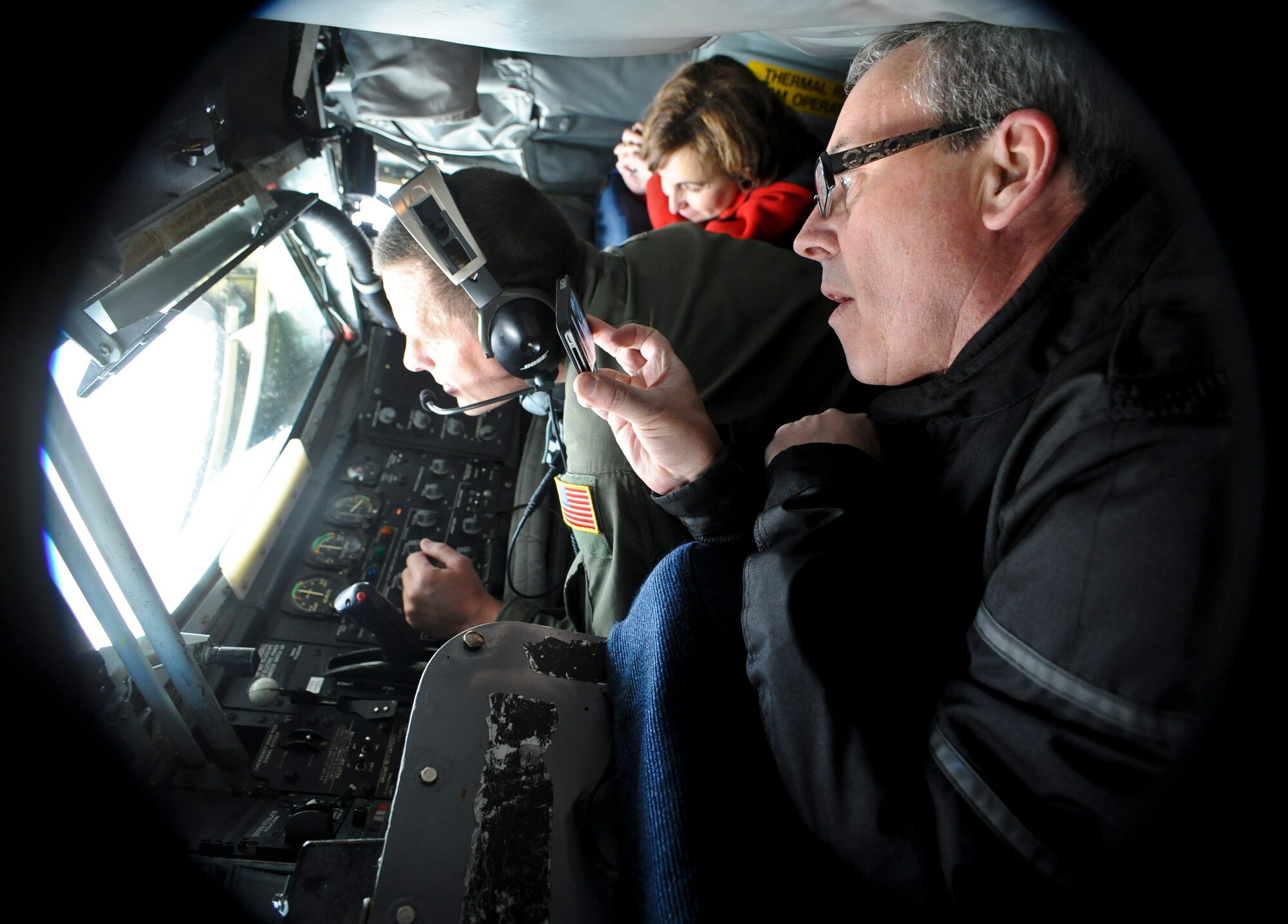 Community members from across the region watch as Master Sgt. Ted Buit, 92nd Operations Group standardization and evaluations boom operator, refuels a flight of F-15 Eagles from the 173rd Fighter Wing at Kingsley Field Air National Guard Base, Ore., during a refueling training mission over Washington and Oregon, March 28, 2012. The training mission was part of an incentive flight allowing members of Fairchild’s local community to experience the base’s primary mission first hand. (U.S. Air Force photo by Senior Airman Benjamin Stratton/Released)