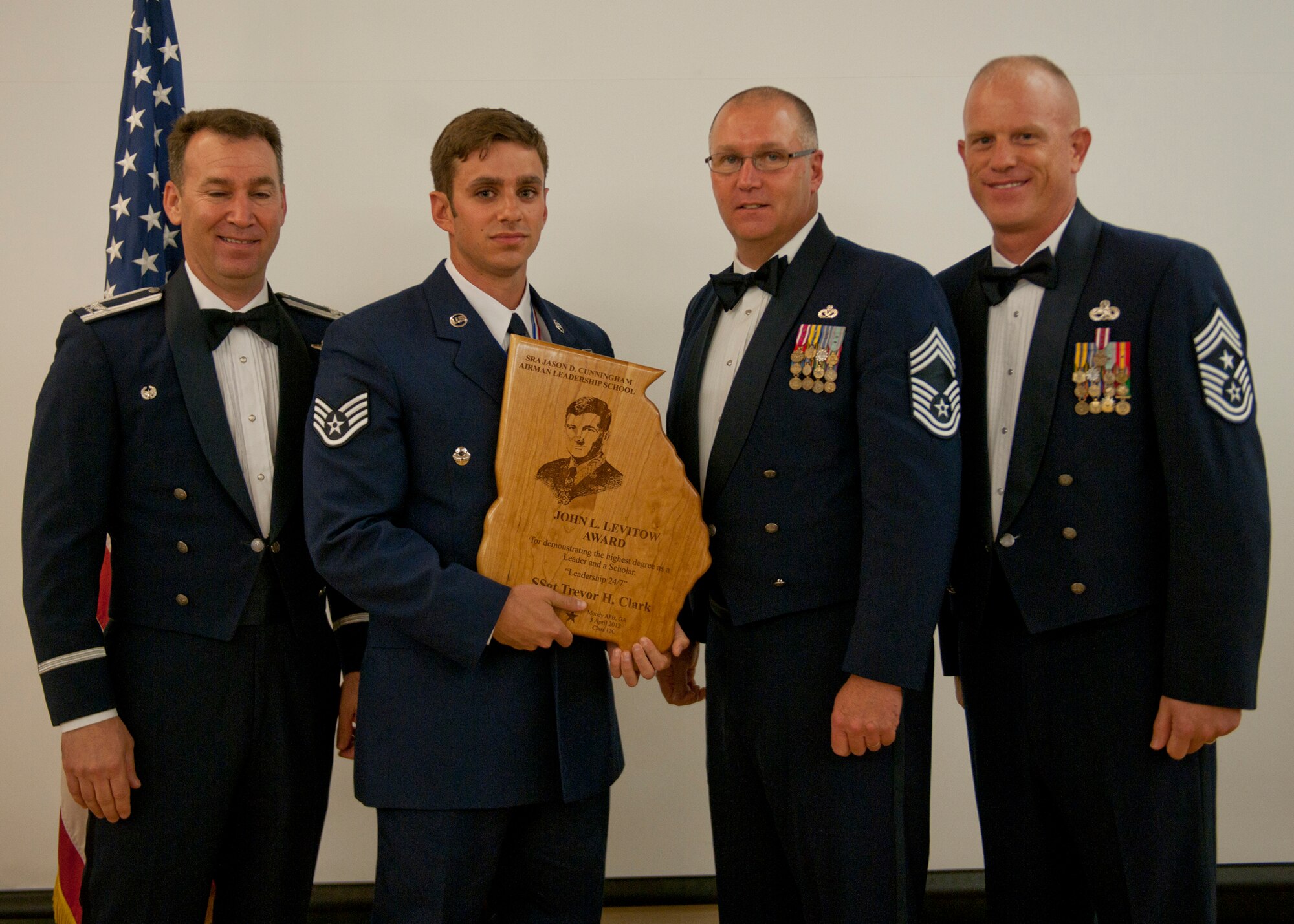 U.S. Air Force Staff Sgt. Trevor Clark, 38th Rescue Squadron, receives the John L. Levitow award during an Airman Leadership School graduation April 3, 2012, at Moody Air Force Base, Ga. The Levitow award is the highest award that can be earned by any graduate, at any level of enlisted professional military education. (U.S. Air Force photo by Senior Airman Eileen Meier/Released)