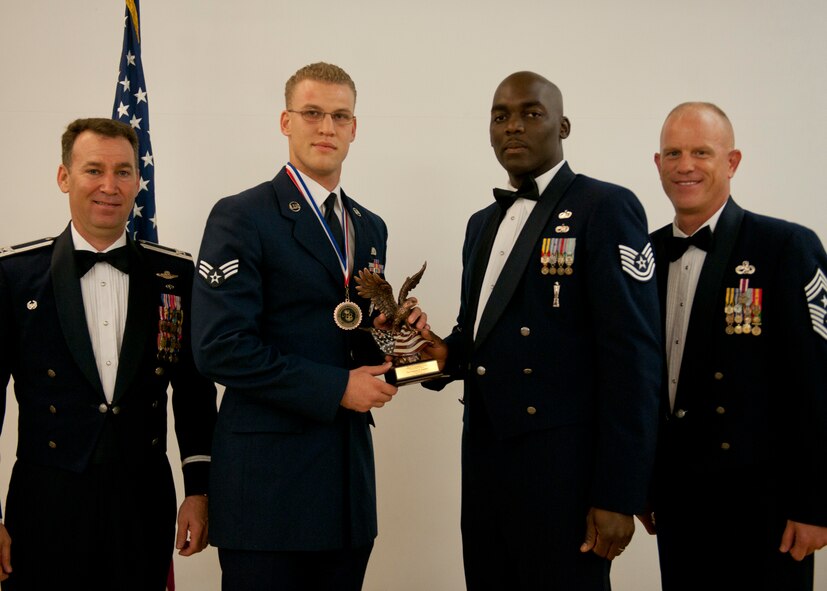 U.S. Air Force Senior Airman Samuel English, 824th Base Defense Squadron, receives a Distinguished Graduate award during an Airman Leadership School graduation April 3, 2012, at Moody Air Force Base, Ga.  This award is presented to the student whose academic performance and leadership skills placed him in the top ten percent of the class. (U.S. Air Force photo by Senior Airman Eileen Meier/Released)