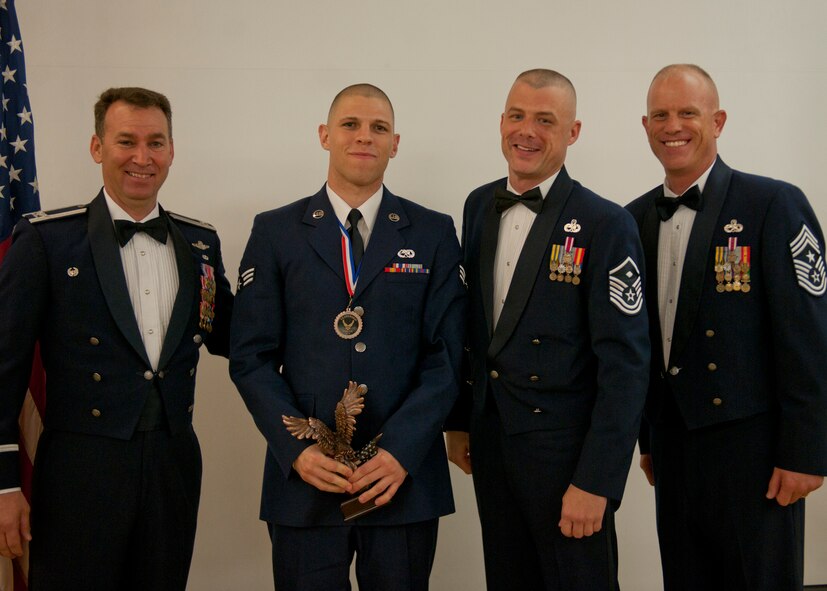 U.S. Air Force Senior Airman Michael Markley, 23d Aircraft Maintenance Squadron, receives a Distinguished Graduate award during an Airman Leadership School graduation April 3, 2012, at Moody Air Force Base, Ga. To receive this award, a student must be placed in the top ten percent of the class by displaying academic performance and leadership skills. (U.S. Air Force photo by Senior Airman Eileen Meier/Released)