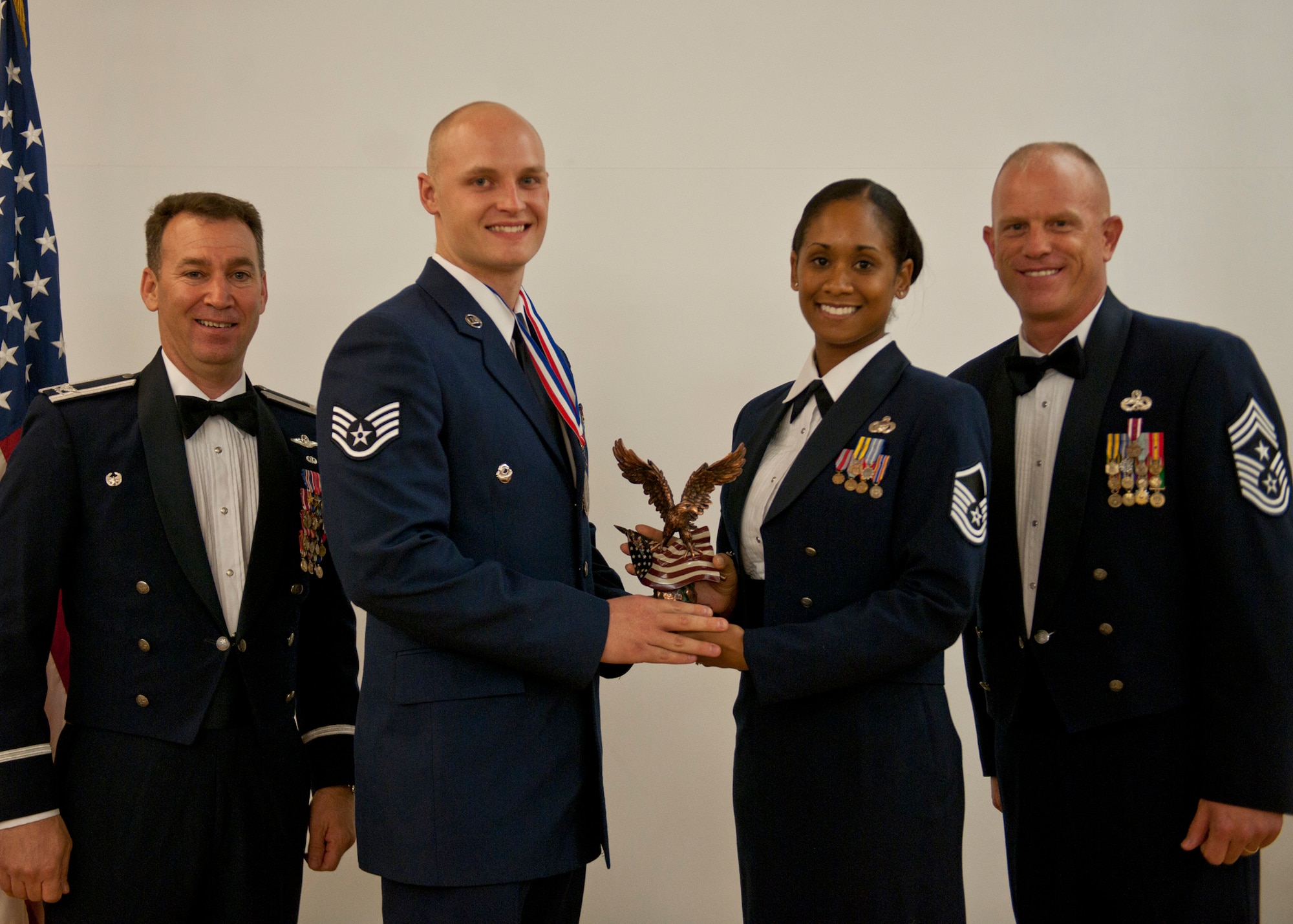 U.S. Air Force Staff Sgt. Ryan Onley, 38th Rescue Squadron, receives a Distinguished Graduate award during an Airman Leadership School graduation April 3, 2012, at Moody Air Force Base, Ga. Onley received this due to his placement in the top ten percent of the class for academic performance and leadership skills. (U.S. Air Force photo by Senior Airman Eileen Meier/Released)