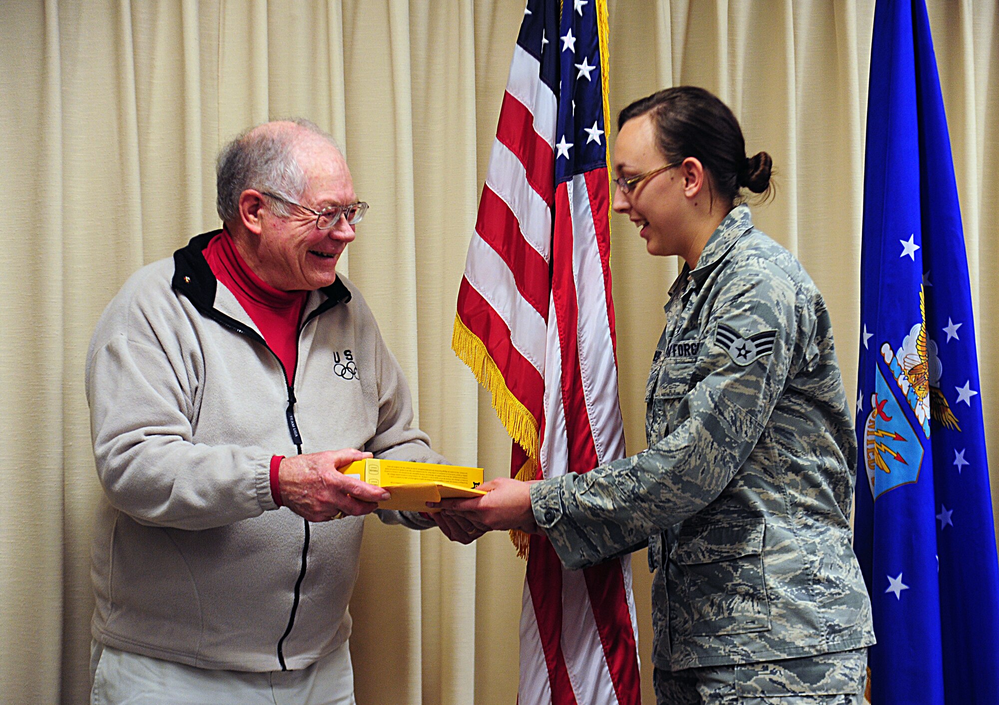 Graham Crutchfield, a retired Marine, pays recognition to Fairchild Airmen by presenting commemorative Buck knives at Fairchild Air Force Base, Wash., March 23, 2012. Each knife is engraved specifically for the branch of service it’s presented to. (U.S. Air Force photo by Airman 1st Class Taylor Curry/Released)