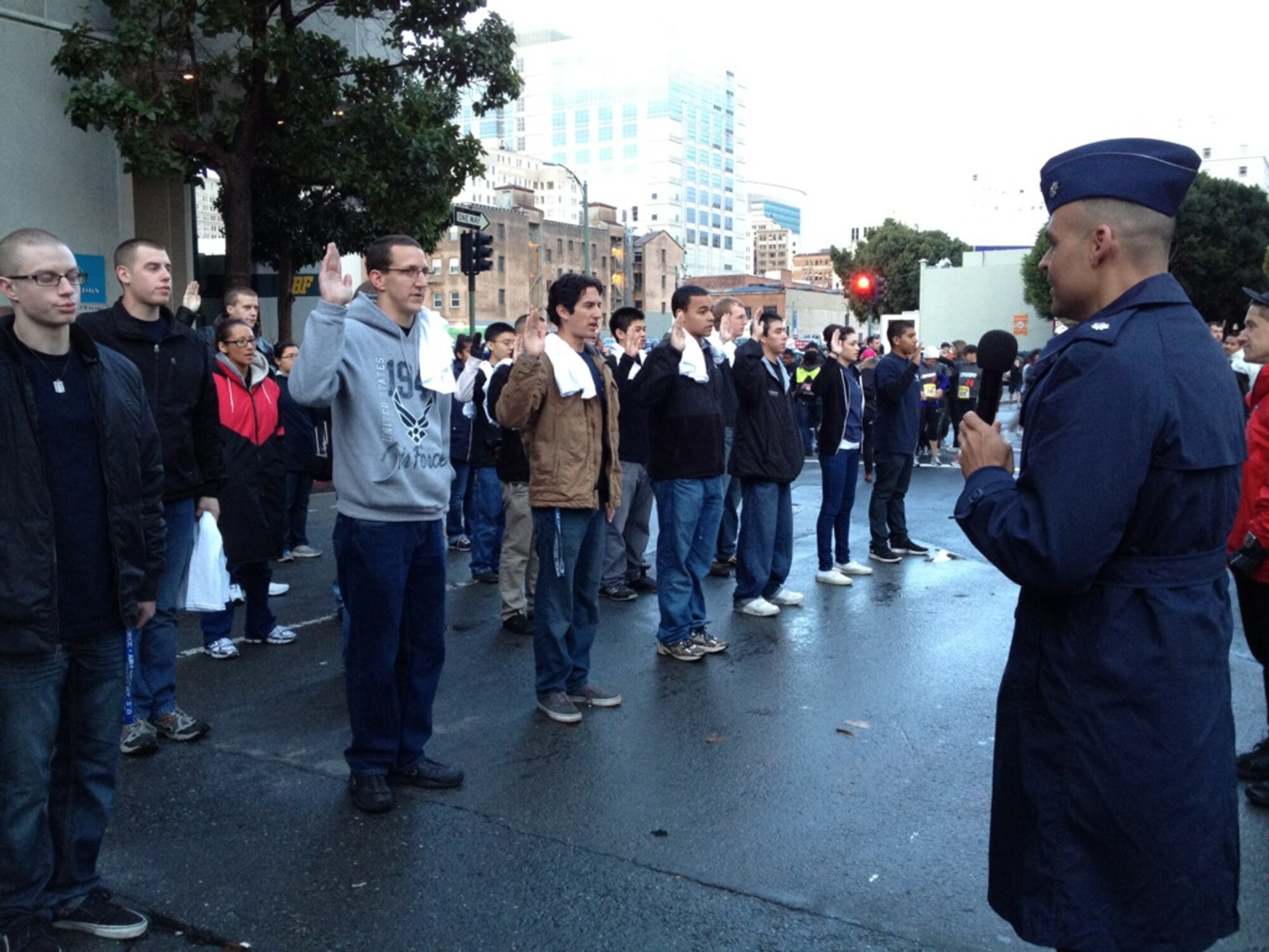 Lt. Col. Eric Espino, 364th Recruiting Squadron commander, administers the oath of enlistment to the 44 newest members of the Delayed Enlistment Program during the pre-start ceremony at the 2012 Oakland Running Festival.  Nineteen squadron members served as race volunteers and 16 squadron members ran the half-marathon, raising over $10K for local charities. (U.S. Air Force photo/Tech. Sgt. Leo Morales)