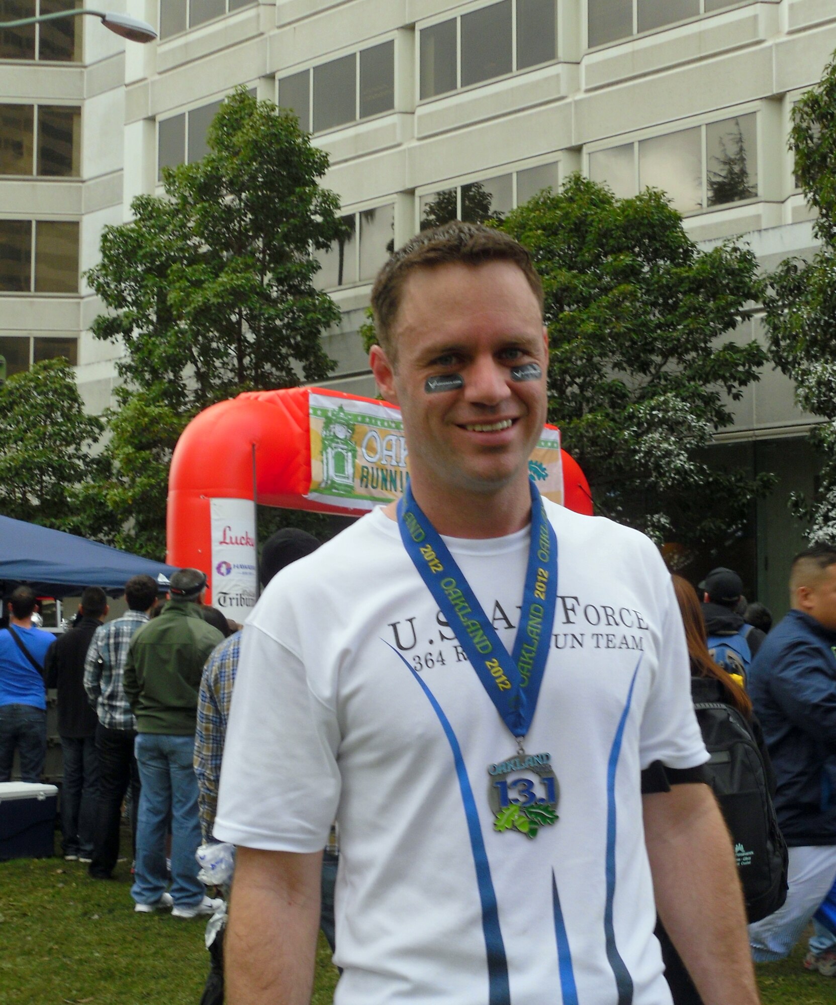 Tech. Sgt. Christopher Johnson, 364th Recruiting Squadron, poses at the finish line after running the half-marathon event at the 2012 Oakland Running Festival.  Johnson served as the Air Force's coordinator for the event which included a 44-person Delayed Enlistment Program swear-in and 19 squadron members working as race volunteers.  Johnson also led the squadron's 16-person running team in a half-marathon run to increase Air Force awareness and raise money for local charities. (U.S. Air Force photo/Tech. Sgt. Leo Morales)