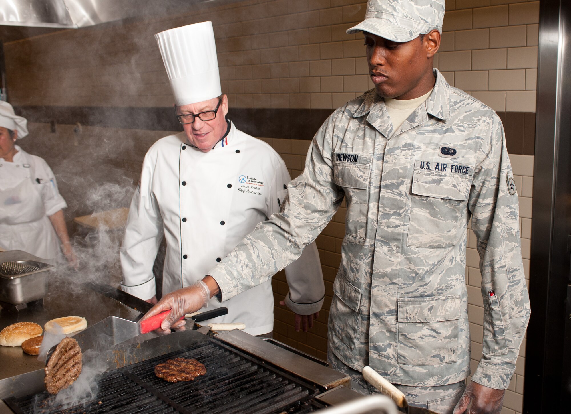 Chef Jacob Knutte, Travis dining facilies executive chef, discusses the art
of the burger with Airman Quintavius Newson, 60th Force Support Squadron.
(U.S. Air Force photo/Ken Wright)
