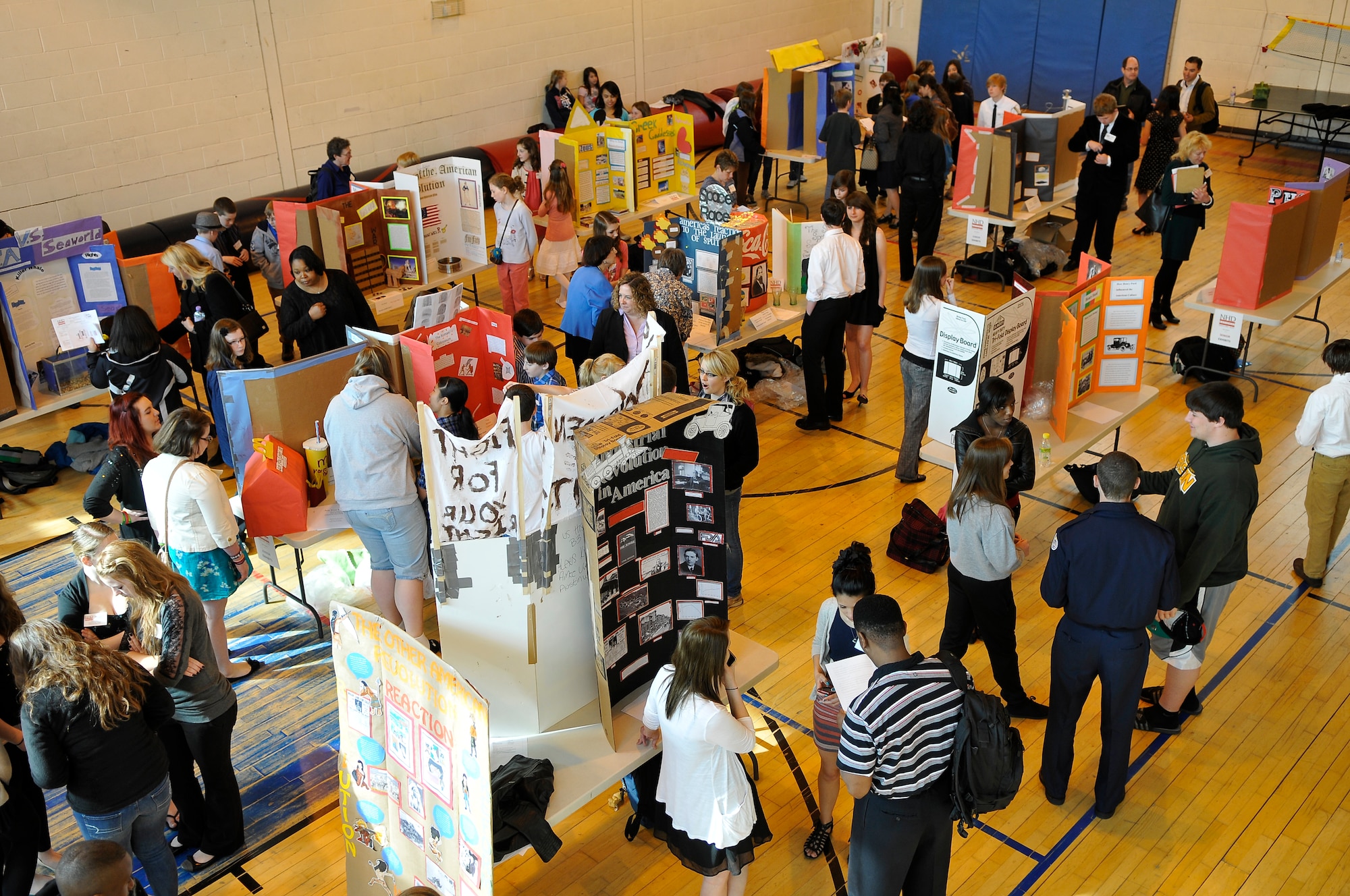 ROYAL AIR FORCE LAKENHEATH, England -- Department of Defense Dependents Schools Europe students from RAFs Alconbury and Lakenheath showcase their exhibits during the National History Day contest at the Lakenheath High School gym April 3, 2012.  National History Day is a national academic program for students grades 6 through 12. The competition benefits students by promoting reading, writing, research skills and building connections with fellow students interested in history. (U.S. Air Force photo by Staff Sgt. Connor Estes)