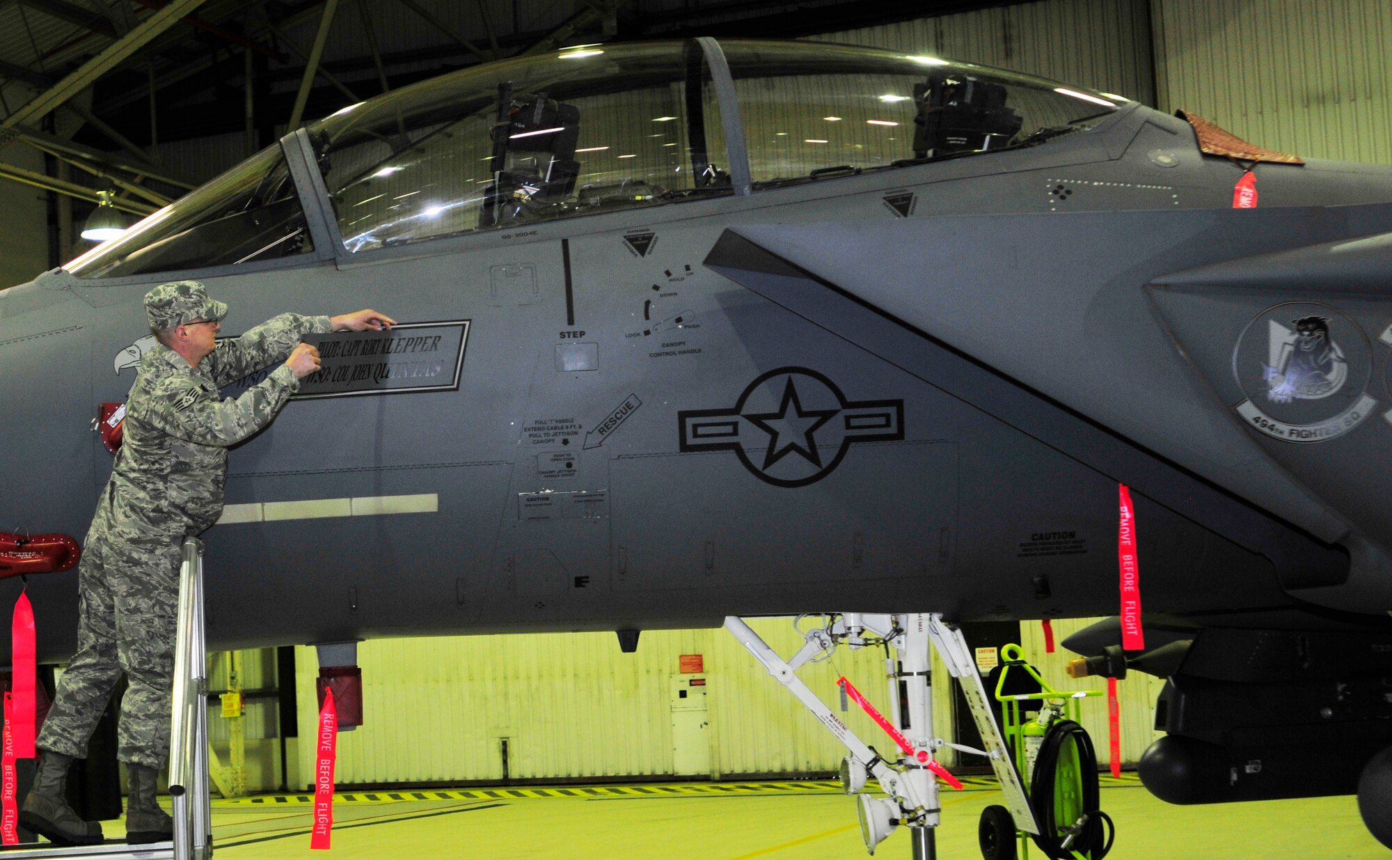 ROYAL AIR FORCE LAKENHEATH, England – Staff Sgt. Charles Armstrong, 48th Aircraft Maintenance Squadron dedicated crew chief, reveals the new commander’s name on an F-15E Strike Eagle during the 48th Fighter Wing change of command ceremony April 5, 2012. (U.S. Air Force photo by Senior Airman Tiffany M. Deuel)
