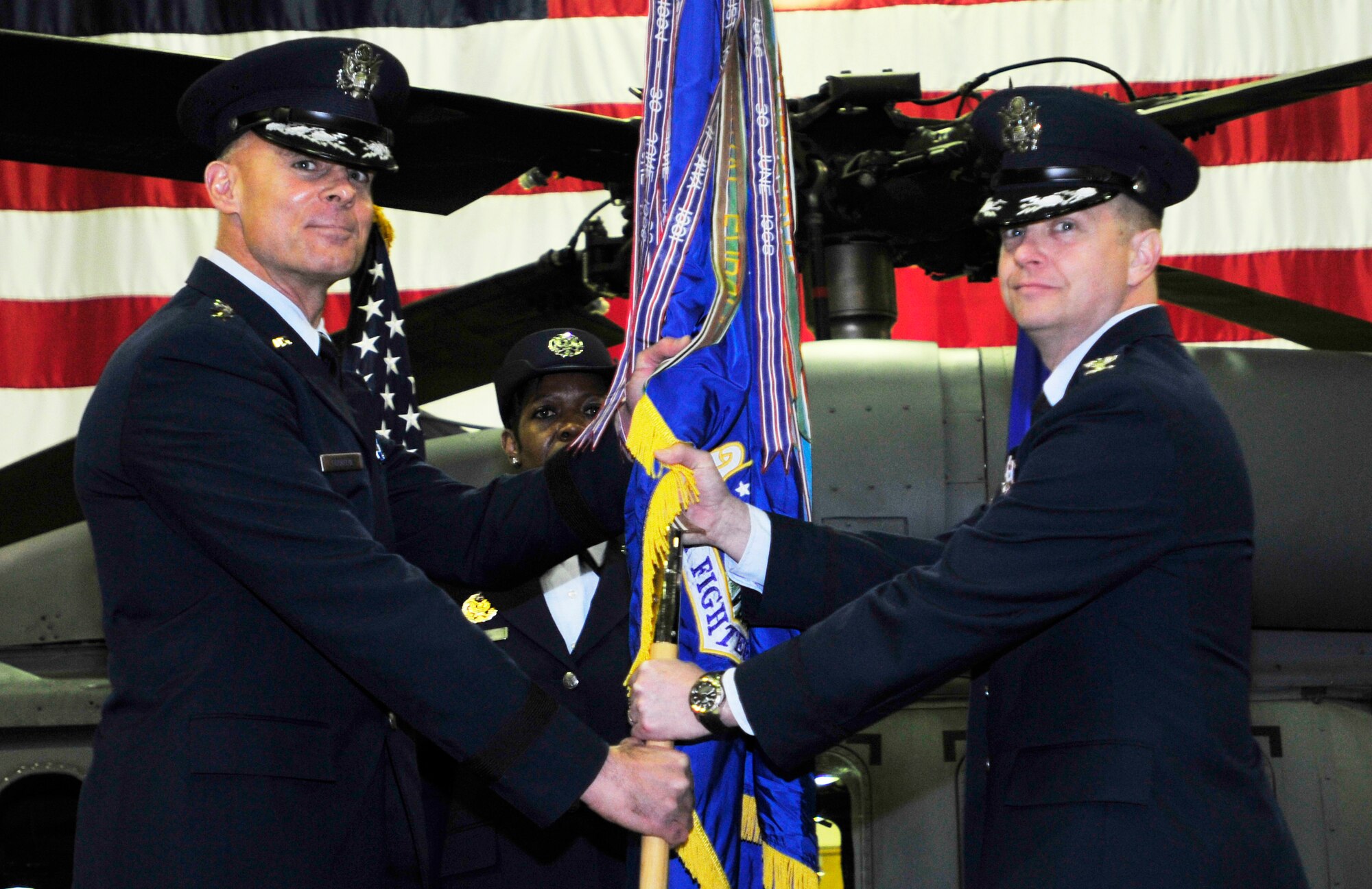 ROYAL AIR FORCE LAKENHEATH, England – Lt. Gen. Craig A. Franklin, 3rd Air Force commander, passes the guidon to Col. Kyle Robinson, incoming 48th Fighter Wing commander, during the 48th FW change of command ceremony April 5, 2012. The outgoing commander, Col. John Quintas, relinquished command of the 48th FW to Col. Robinson. (U.S. Air Force photo by Senior Airman Tiffany M. Deuel)