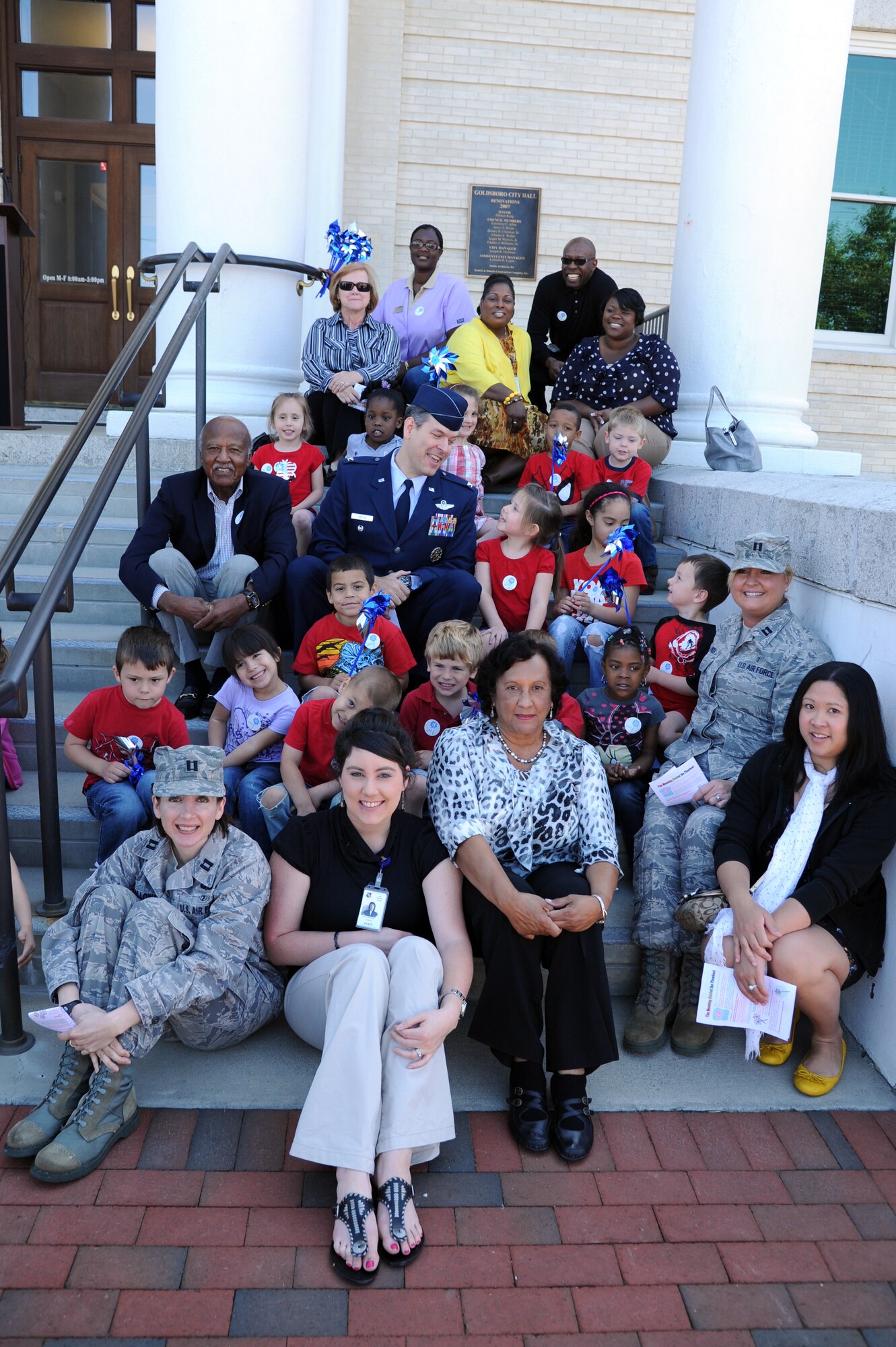U.S. Air Force Col. Gabriel Green talks to Evangeline Ayer, 5, during a group photo at the Child Abuse Prevention Month proclamation ceremony at City Hall in Goldsboro, N.C., April 3, 2012. Green, Alfonzo King and Seymour Johnson’s family advocacy office promoted child abuse prevention on base and among the local community during the event. Green, 4th Fighter Wing vice commander, hails from Jackson, Miss. Ayer is the daughter of U.S Air Force Airman 1st Class Jesse Ayer, 4th Aircraft Maintenance Squadron weapons load crew member from Grass Valley, Calif. King is the mayor of Goldsboro and is from Mt. Olive, N.C. (U.S. Air Force photo/Senior Airman Whitney Stanfield/Released)
