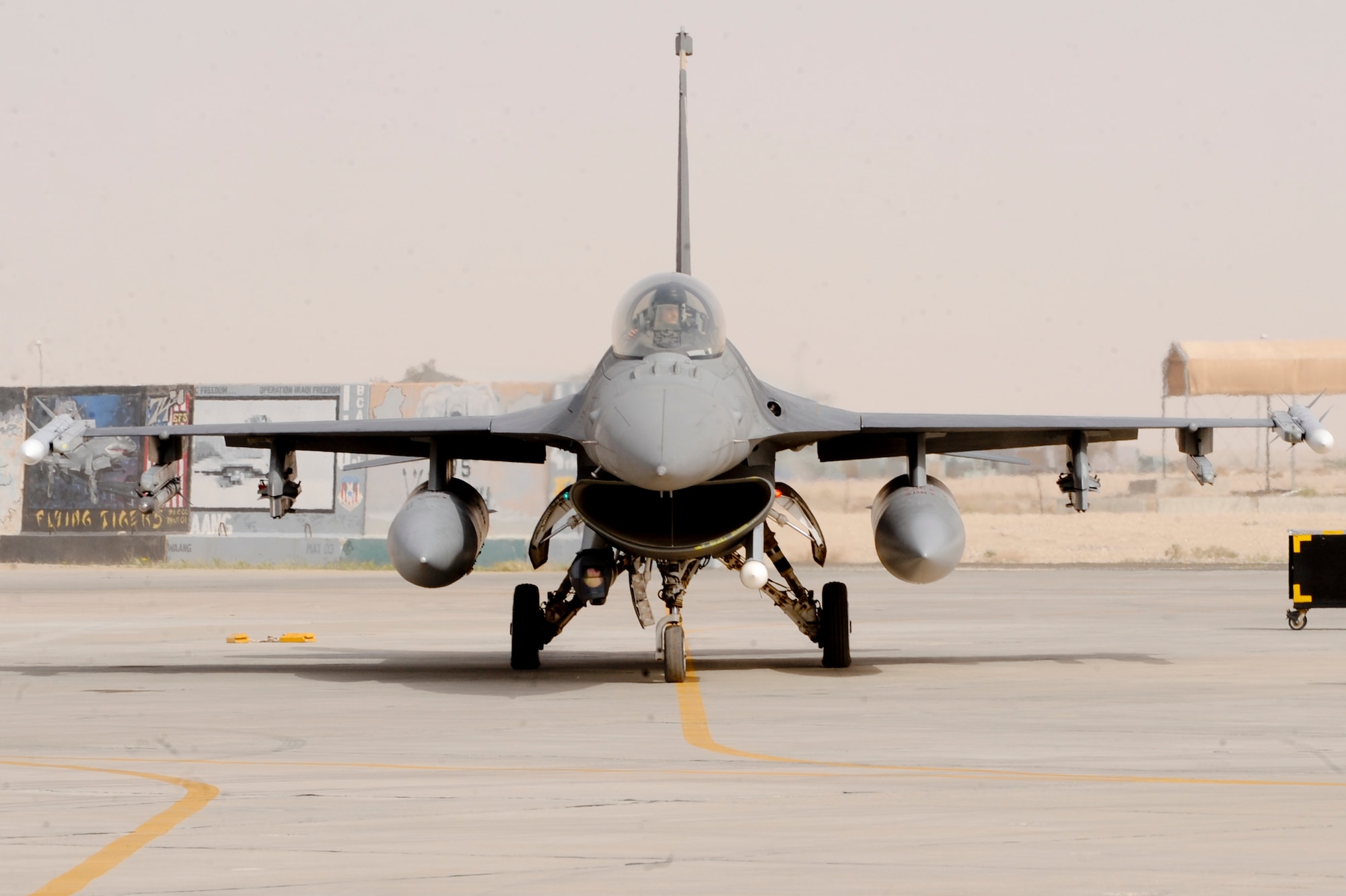 SOUTHWEST ASIA -- A pilot from the 79th Expeditionary Fighter Squadron, prepares to taxi out for a training mission here, April 3, 2012. Crew chiefs from the 332nd Expeditionary Aircraft Maintenance Squadron signal to pilots to let them know it is clear to taxi their aircraft. (U.S. Air Force photo by Staff Sgt. Joshua J. Garcia)