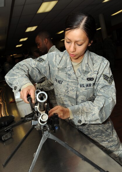 MINOT AIR FORCE BASE, N.D. -- Senior Airman Susana Galvez, 5th Security Forces Squadron response force member, finishes a weapons check of her M-249 Squad Automatic Weapon here March 26. (U.S. Air Force photo/Senior Airman Jose L. Hernandez)


