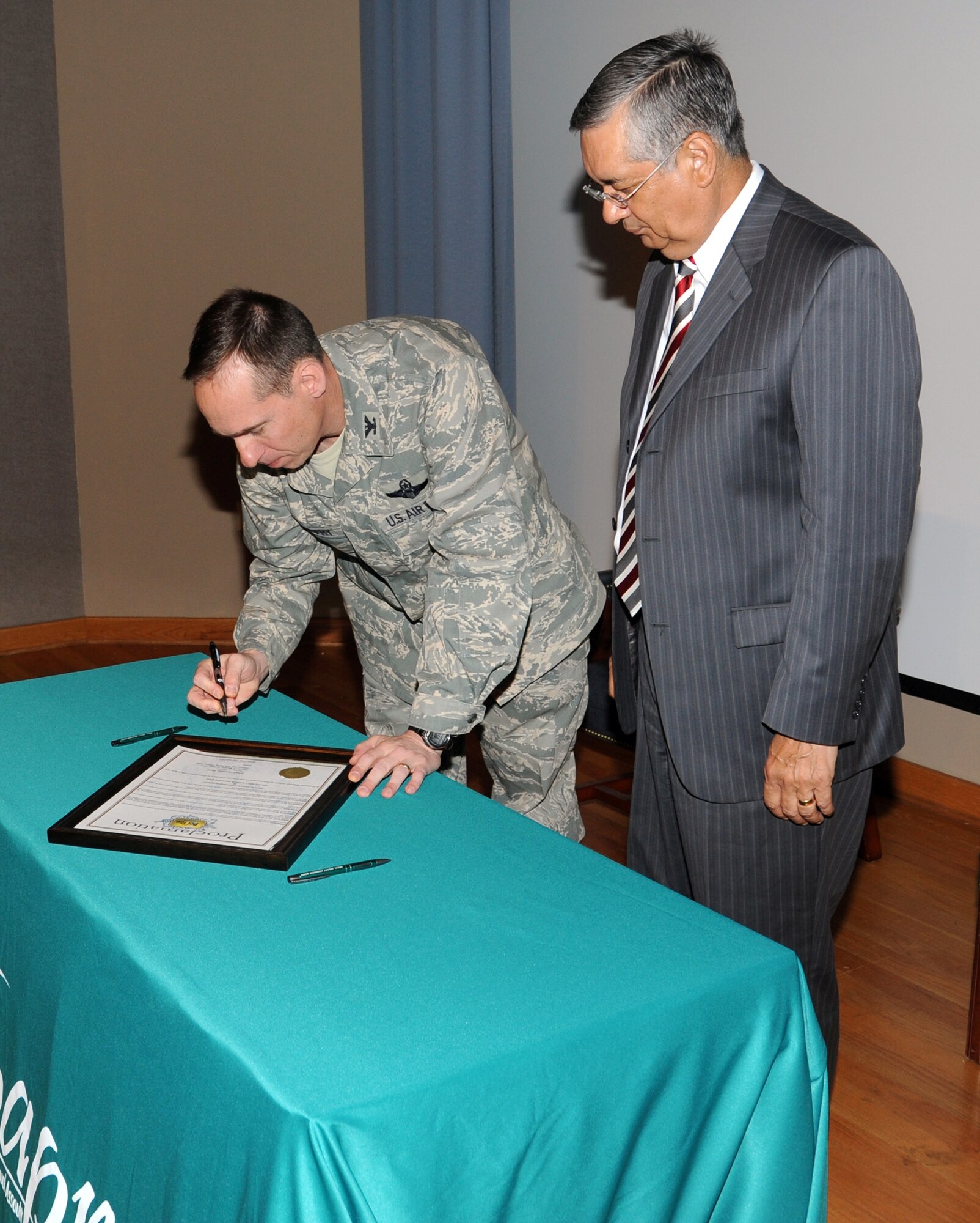 Col. Tom Murphy, 47th Flying Training Wing commander, teamed up with Roberto Fernandez, Mayor of Del Rio, Texas, at Laughlin Air Force Base, Texas, April 4, 2012 for the annual Sexual Assault Awareness Month proclamation signing. (U.S. Air Force photo/Jose Mendoza) 