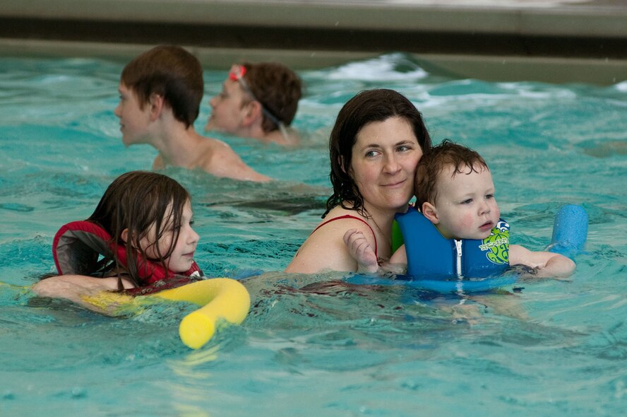 HANSCOM AIR FORCE BASE, Mass. - Christy Lardner (center) swims with her son, Josiah, and daughter, Eileen, at the Polar Plunge Hearts Apart at the base pool march 28. The Airman and Family Readiness Center sponsored the event, which supports families of deployed, remote tour and extended TDY service members. (U.S. Air Force Photo by Mark Herlihy)