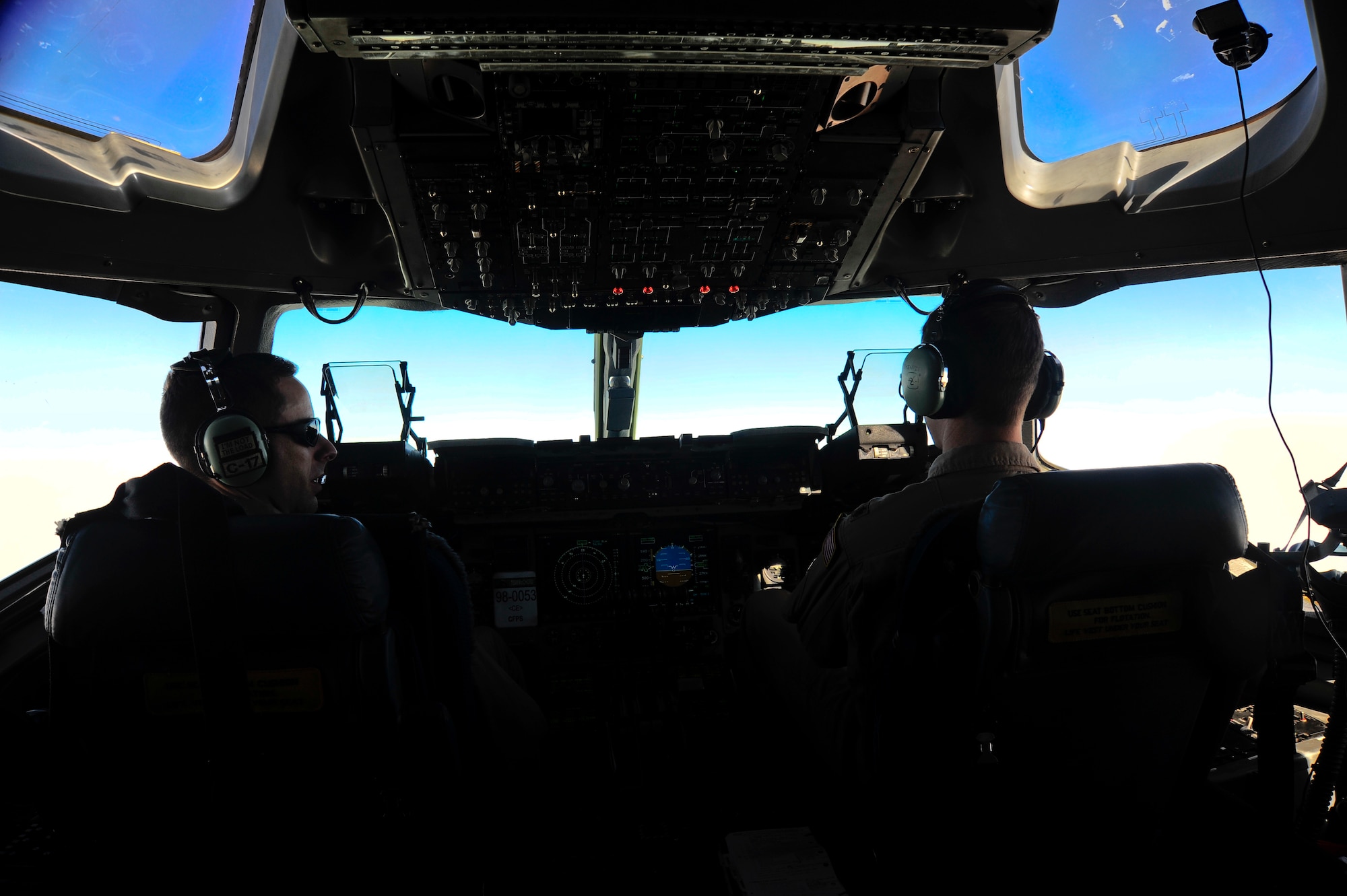 Capt. Bill Scharfenberg and Maj. Wes Skenfield command a C-17 Globemaster III 25,000 feet in the air March 20, 2012. Scharfenberg and Skenfield are 817th Expeditionary Airlift Squadron Detachment 1 C-17 Globemaster III pilots deployed to the Transit Center at Manas, Kyrgyzstan, from Joint Base Lewis-McChord, Wash. In the past year, the 817th EAS Det. 1 has transported an average 26,500 passengers and 11 million pounds of cargo each month. (U.S. Air Force photo/Staff Sgt. Angela Ruiz)