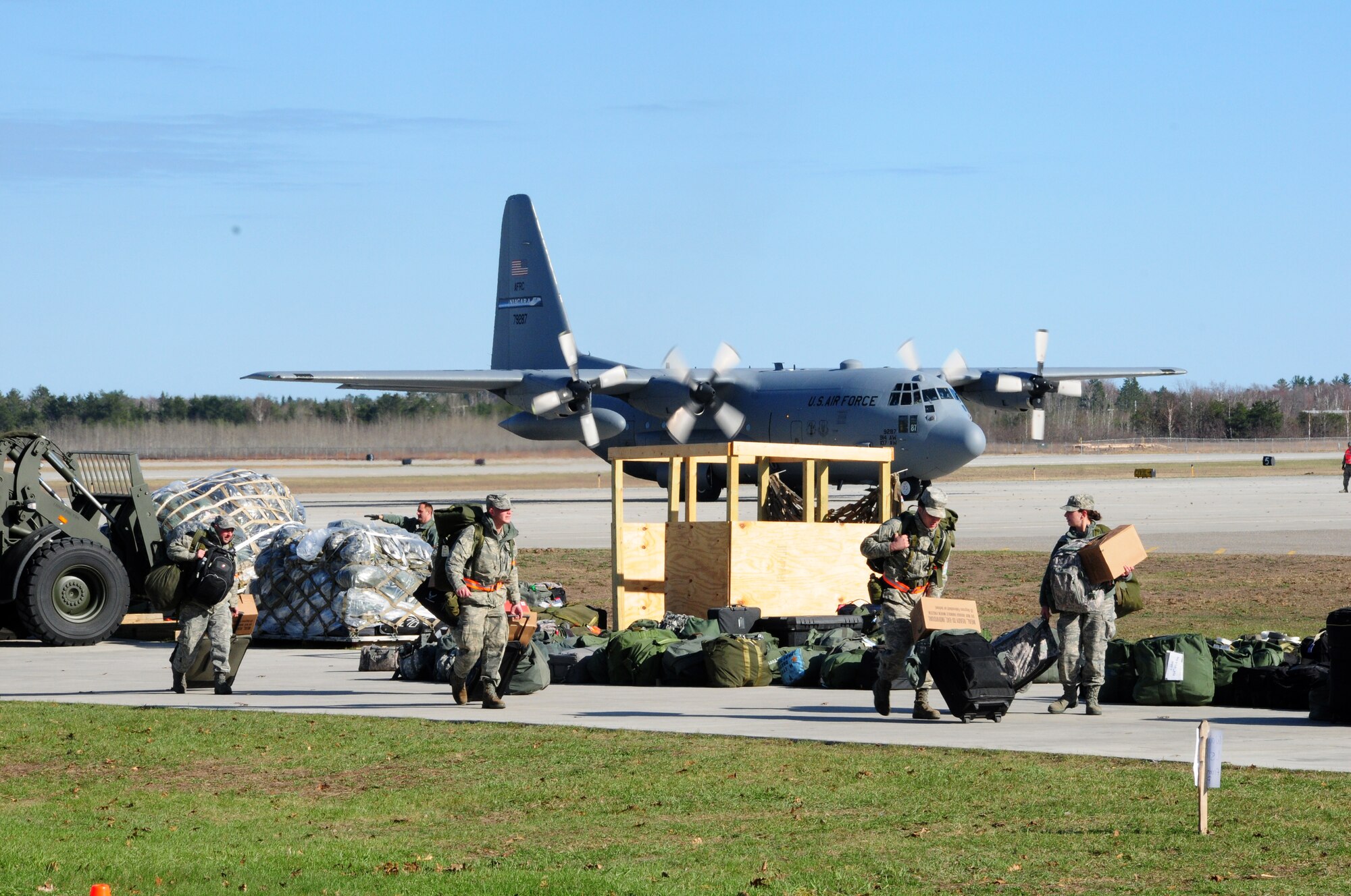 Airmen collect baggage shortly after arriving at Alpena, Michigan Combat Readiness Training Center and prepare for a training exercise.  Exercises such as these ensure Airmen are current, qualified, and ready to fight. (U.S. Air Force photo by Senior Airman Jessica Mae Snow)
