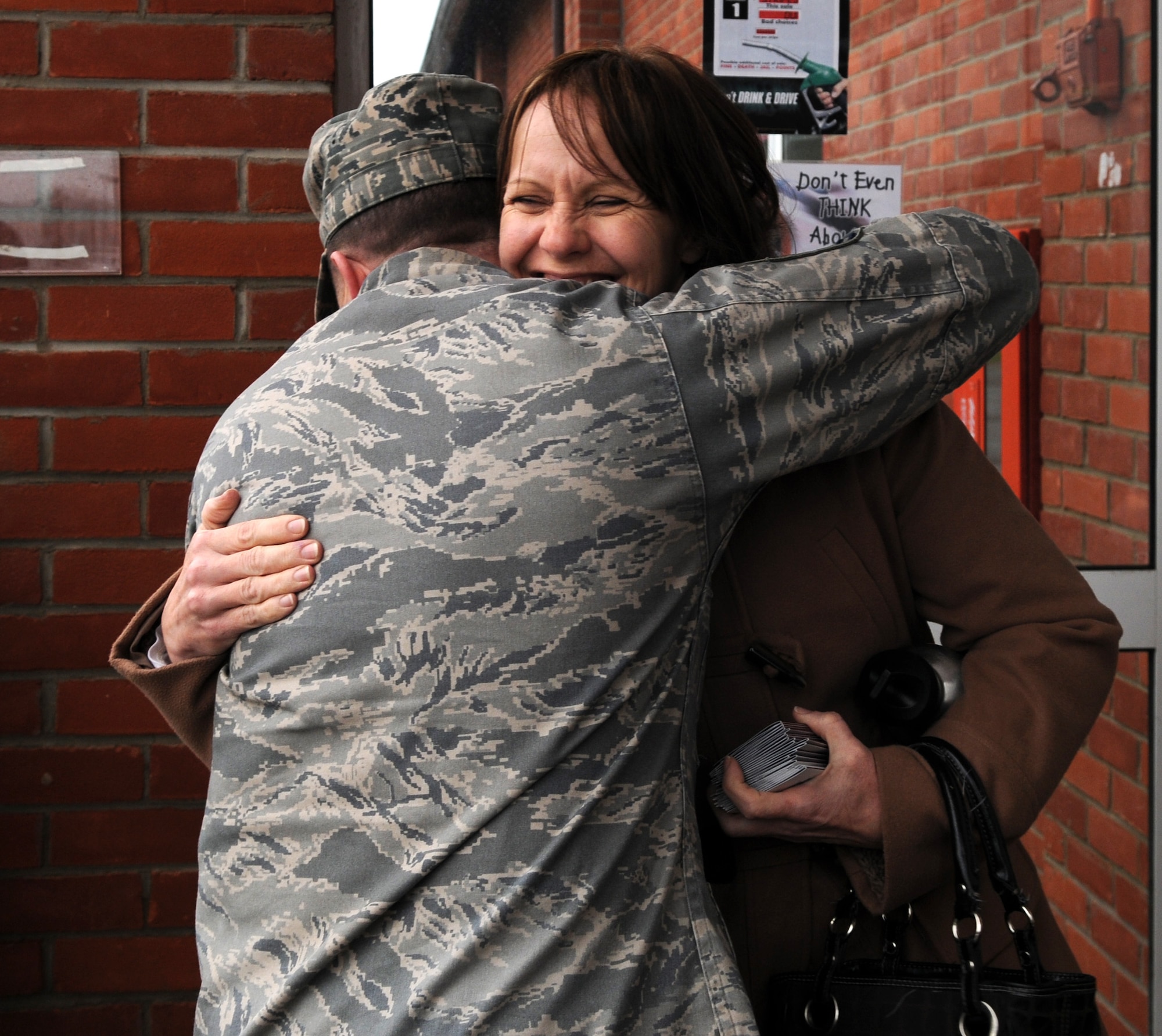 RAF MILDENHALL, England – A Team Mildenhall Airman shows his appreciation to a member of the RAF Mildenhall Officers’ and Civilians’ Spouses’ Club after she presented him a $30 gift card to help pay for his fuel April 4, 2012, at the RAF Mildenhall Shoppette. The MOCSC performs random acts of kindness monthly for all Team Mildenhall members. (U.S. Air Force photo/Senior Airman Rachel Waller)   