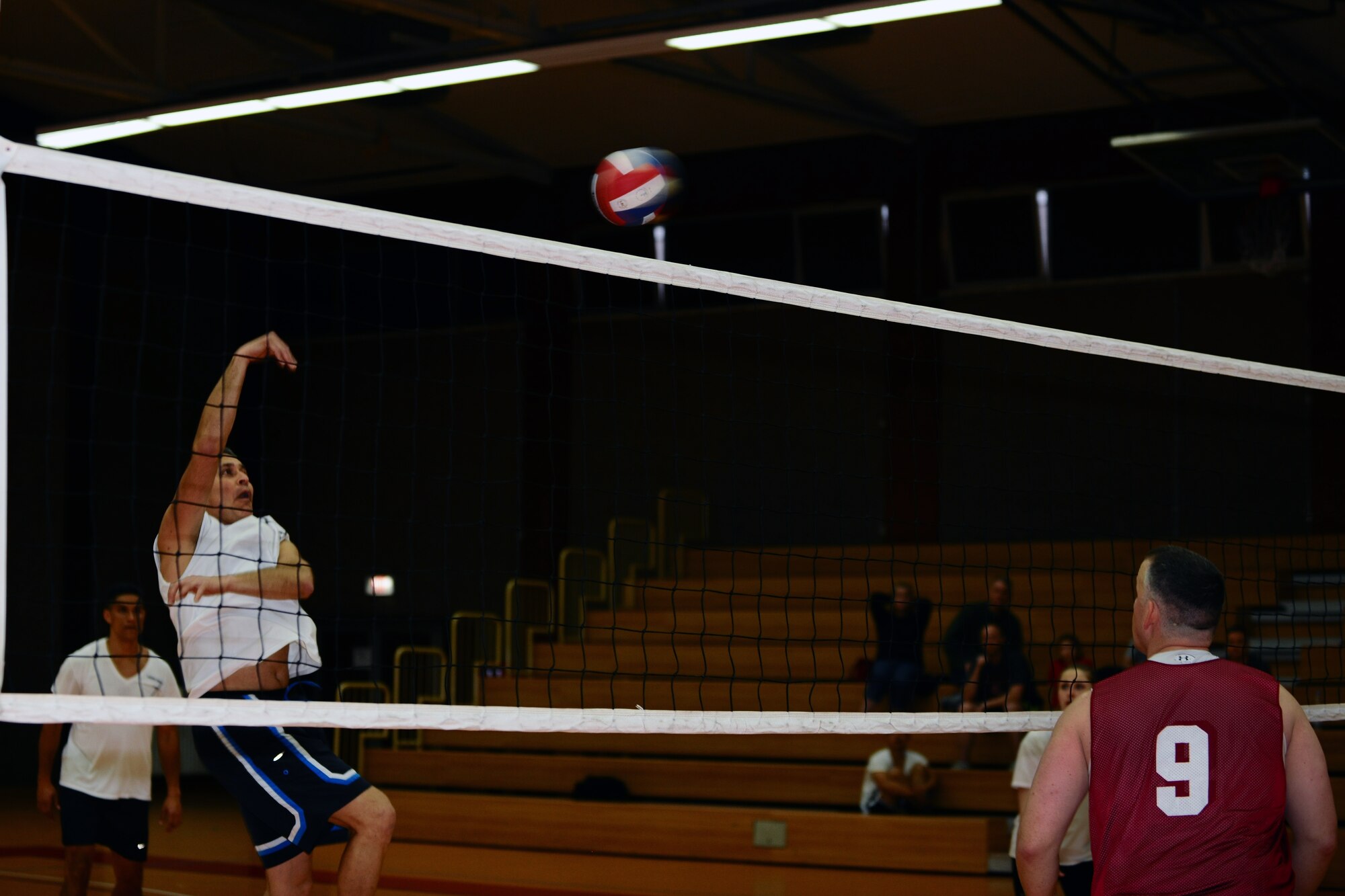 SPANGDAHLEM AIR BASE, Germany – Jose Becerra, 606th Air Control Squadron, returns a volleyball over the net during the intramural volleyball championship game at the Skelton Memorial Fitness Center here April 3. ACS defeated the 702nd 21-25, 25-19 and 15-8 in the final game of the double-elimination tournament. The tournament included nine teams comprised of Airmen and family members from different squadrons throughout Spangdahlem AB. (U.S. Air Force photo by Airman 1st Class Dillon Davis/Released)