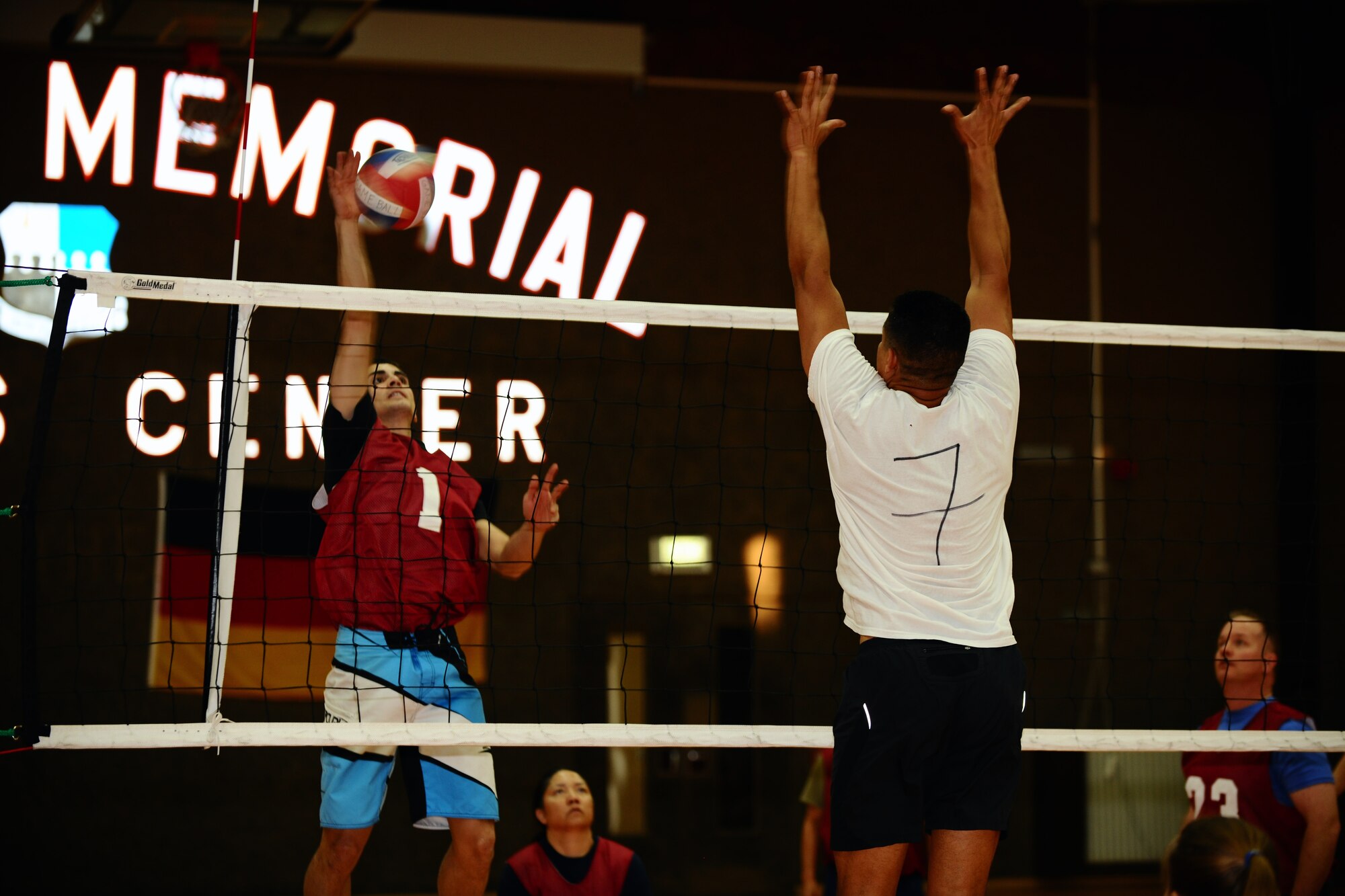 SPANGDAHLEM AIR BASE, Germany – Jared Rand, Spangdahlem American Forces Network, spikes a volleyball at Anthony Owens, 606th Air Control Squadron, as he attempts to block it during the intramural volleyball championship game at the Skelton Memorial Fitness Center here April 3. ACS defeated the 702nd Munitions Support Squadron 21-25, 25-19 and 15-8 in the final game of the double-elimination tournament. The tournament included nine teams comprised of Airmen and family members from different squadrons throughout Spangdahlem AB. (U.S. Air Force photo by Airman 1st Class Dillon Davis/Released)