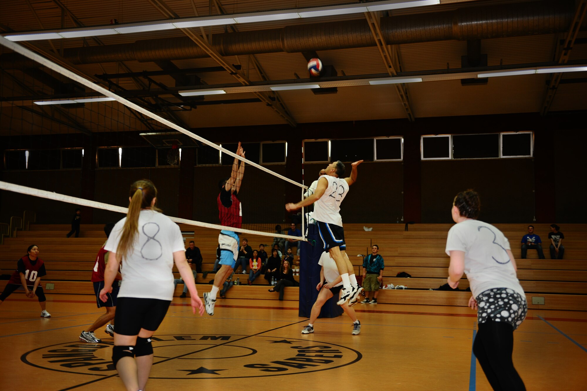 SPANGDAHLEM AIR BASE, Germany – Jose Becerra, 606th Air Control Squadron, goes to spike a ball over Jared Rand, Spangdahlem American Forces Network, during the intramural volleyball championship at the Skelton Memorial Fitness Center here April 3. ACS defeated the 702nd Munitions Support Squadron 21-25, 25-19 and 15-8 in the final game of the double-elimination tournament. The tournament included nine teams comprised of Airmen and family members from different squadrons throughout Spangdahlem AB. (U.S. Air Force photo by Airman 1st Class Dillon Davis/Released)