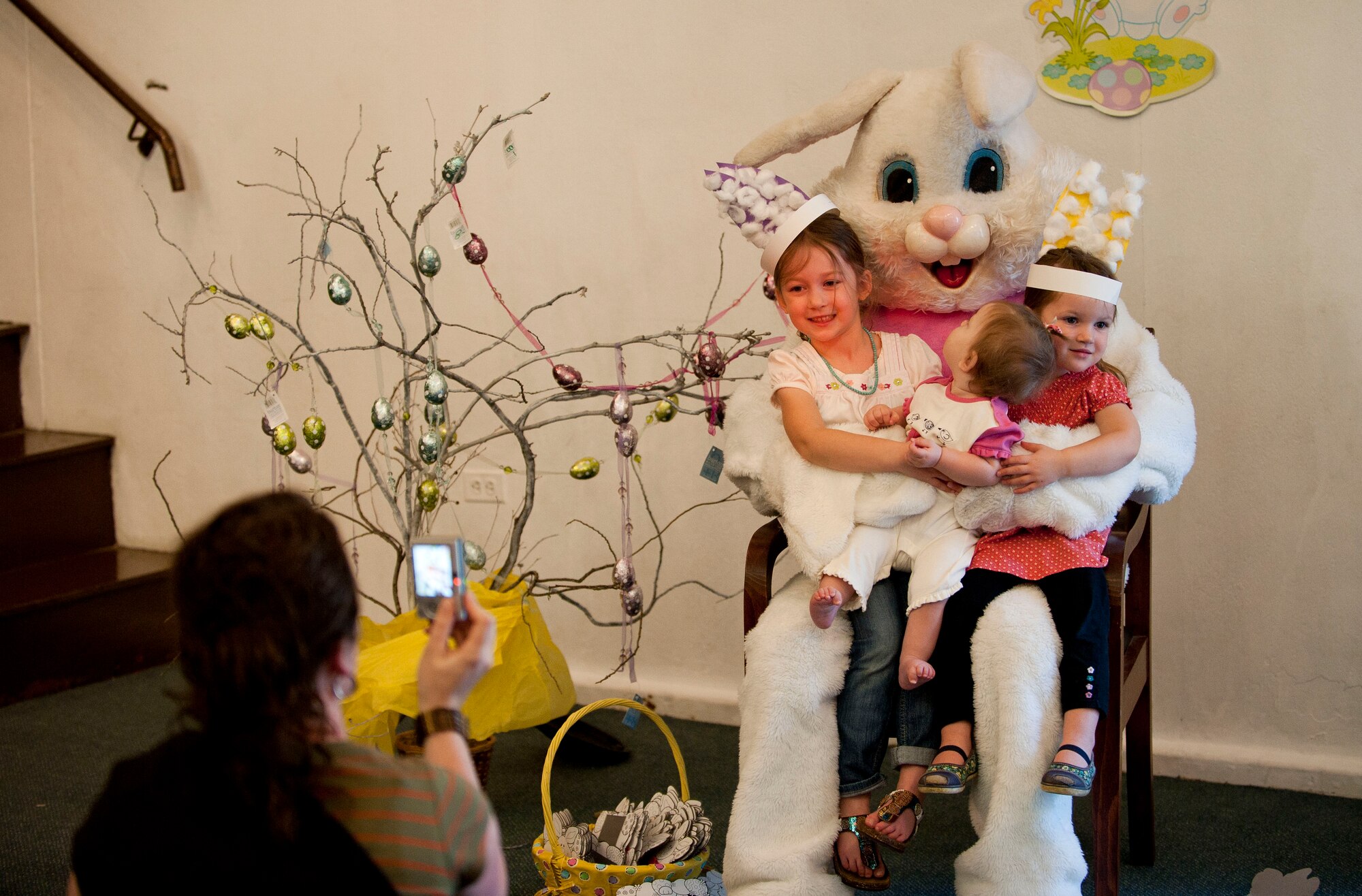 Marlo Greer takes a photo of her children with the Easter bunny at the Easter Bunny Kids at Play event April 4, 2012, at Incirlik Air Base, Turkey. The event was hosted by the 39th Force Support Squadron and included various arts and crafts, games, and an egg hunt. (U.S. Air Force photo by Senior Airman Clayton Lenhardt/Released)