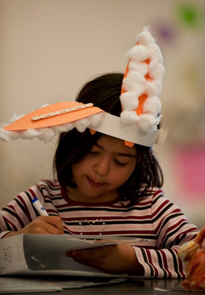 A child decorates a basket at the Easter Bunny Kids at Play event April 4, 2012, at Incirlik Air Base, Turkey. The event was hosted by the 39th Force Support Squadron and included games, a chance to take photos with the Easter bunny, and an egg hunt. (U.S. Air Force photo by Senior Airman Clayton Lenhardt/Released)