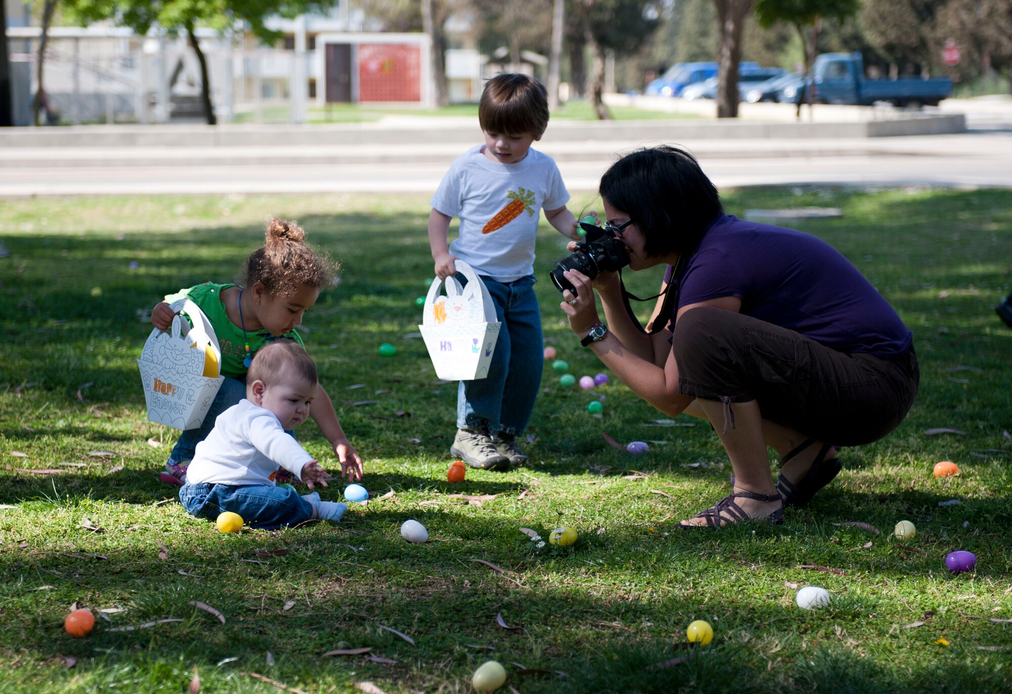 Christina Ellis takes photos of her children hunting for eggs at the Easter Bunny Kids at Play event April 4, 2012, at Incirlik Air Base, Turkey. The event was hosted by the 39th Force Support Squadron and included arts and crafts, games, and a chance to take photos with the Easter bunny. (U.S. Air Force photo by Senior Airman Clayton Lenhardt/Released)