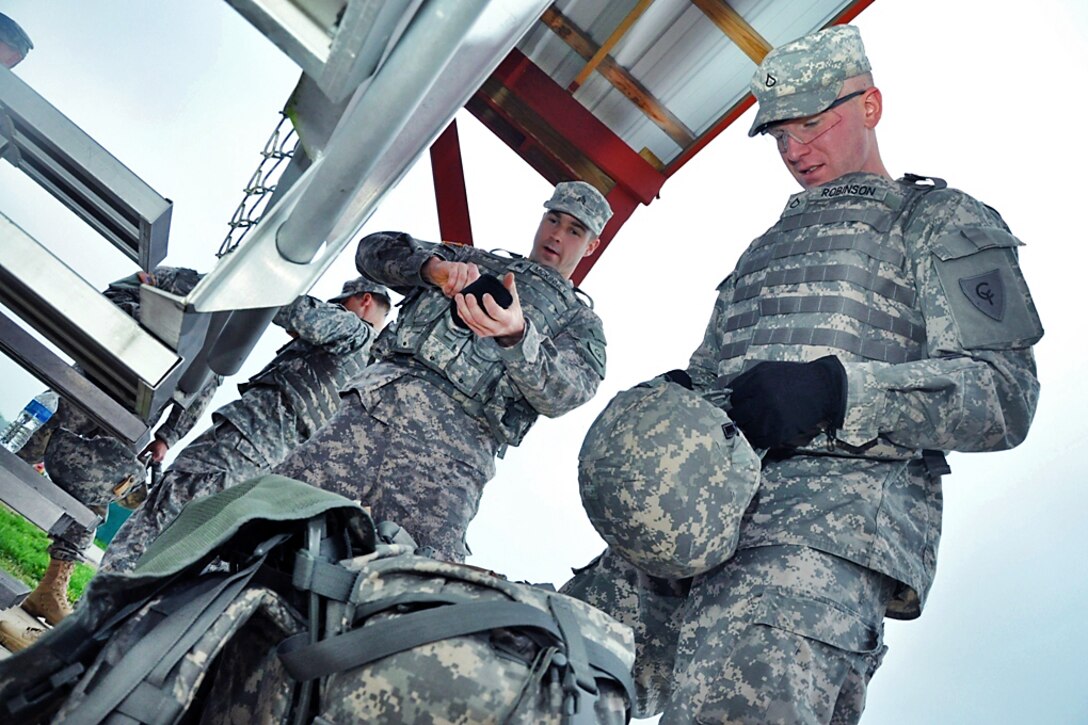 Army Sgt. Brandon McKinney, and Pfc. Matt Robinson prepare for the ...